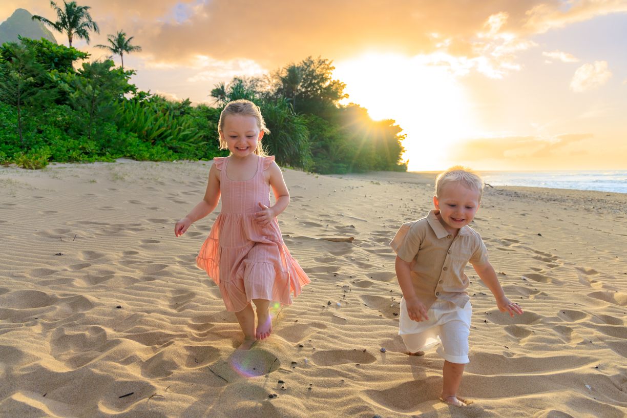 Golden sunset illuminates family beach photography session in Hawaii.