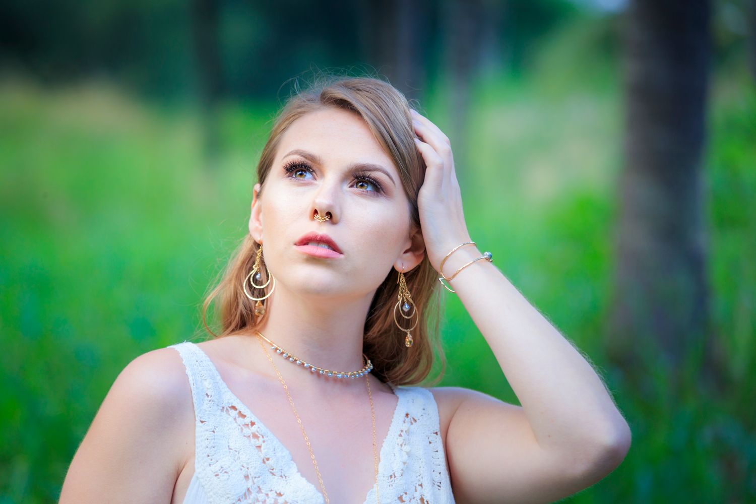 Ethereal outdoor portrait session in a lush green forest setting.