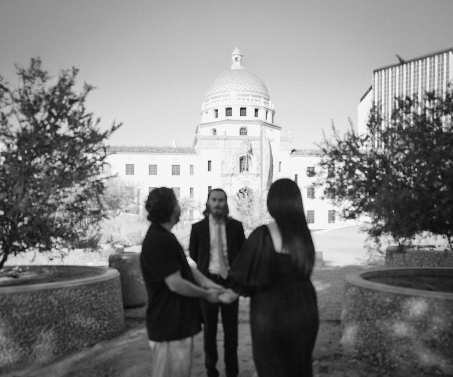 Black and white panorama of mission architecture with domed towers and walkways.