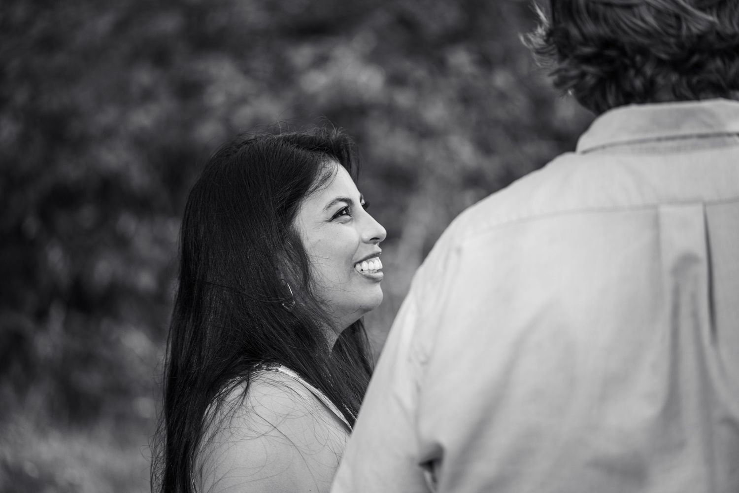 Black and white candid moment captured during outdoor photoshoot.