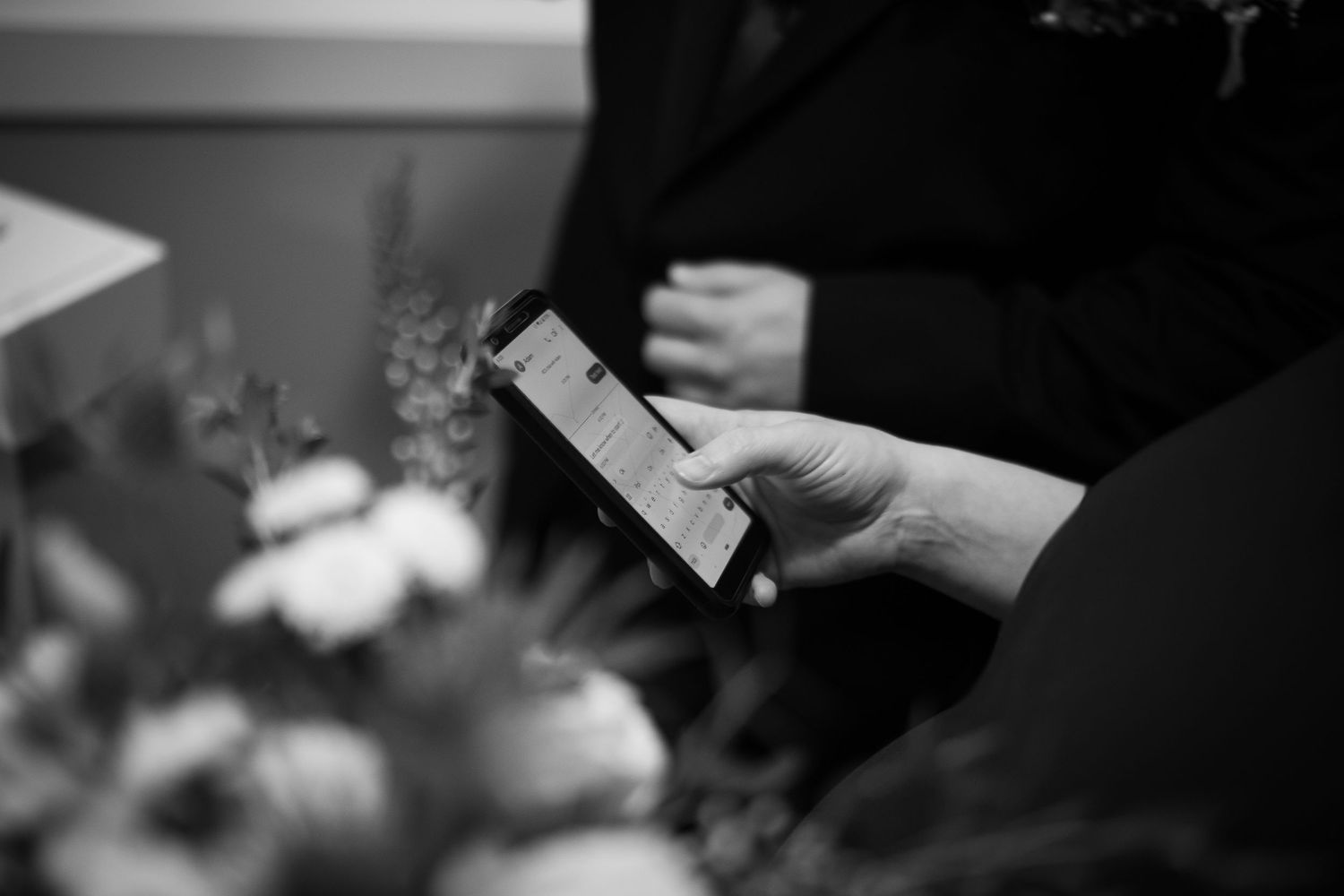 Close-up of hands exchanging rings during an intimate wedding ceremony.
