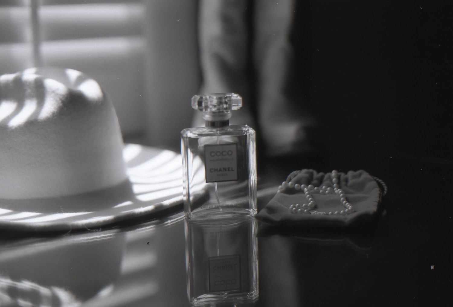 Elegant perfume bottles photographed in soft focus black and white.
