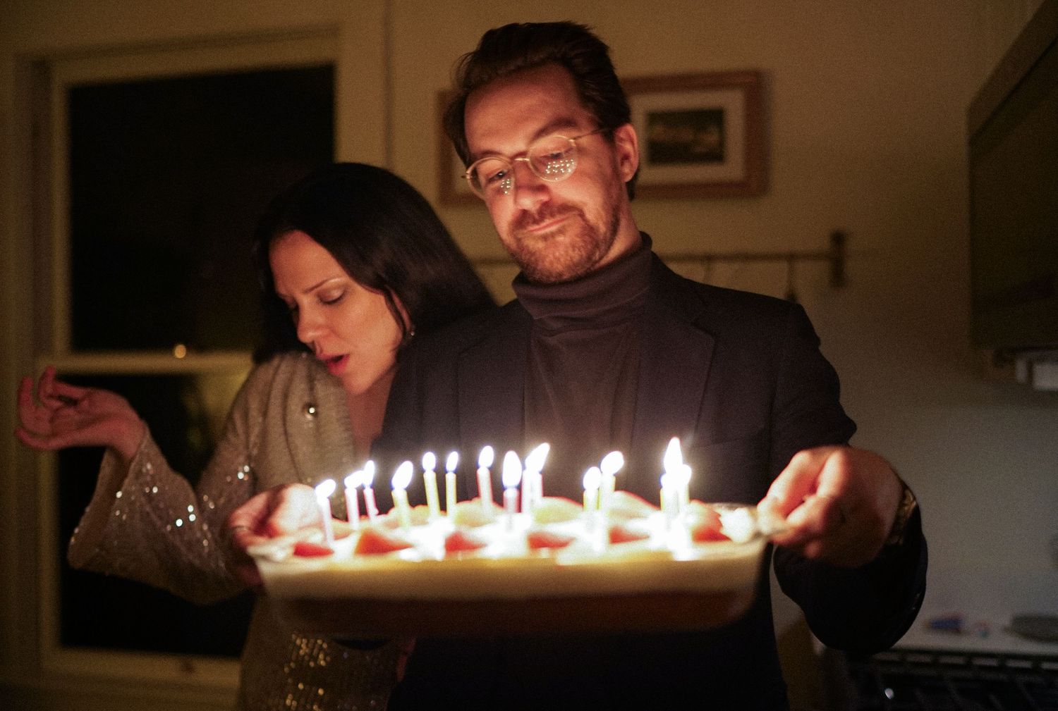 A celebratory moment with lit birthday candles on a dessert tray.