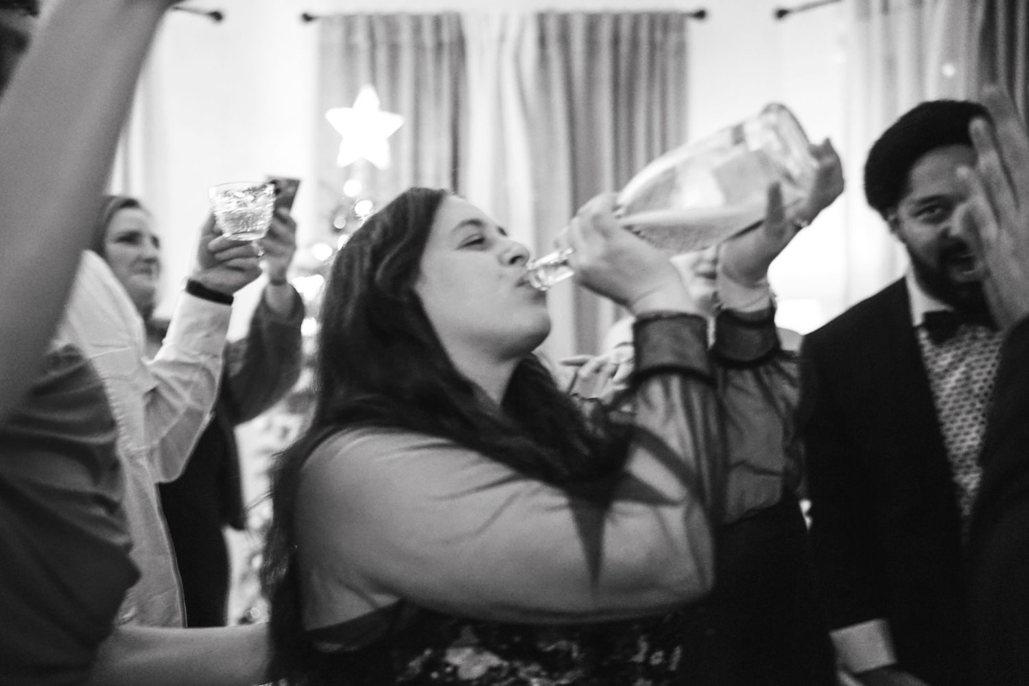 People raising glasses in a toast during a celebration.