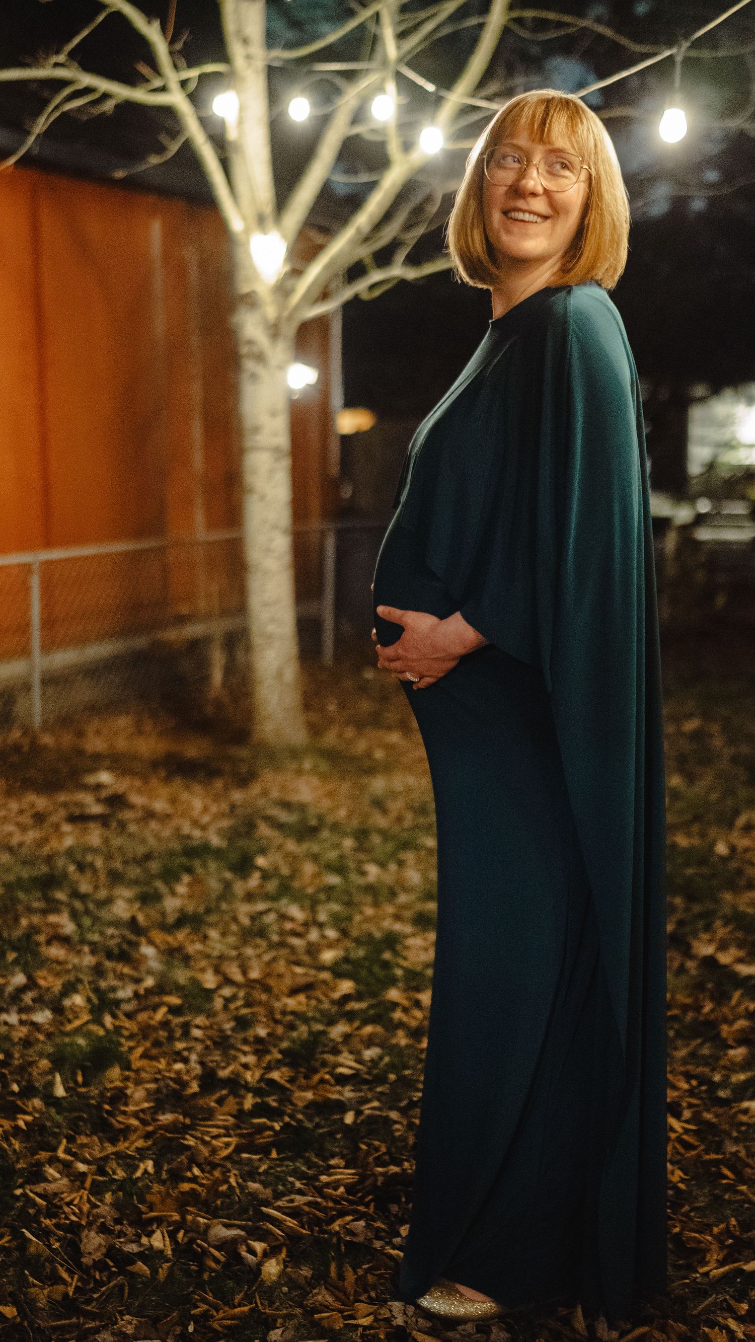 A series of nighttime portraits in a park with string lights and fallen autumn leaves creating a magical atmosphere.