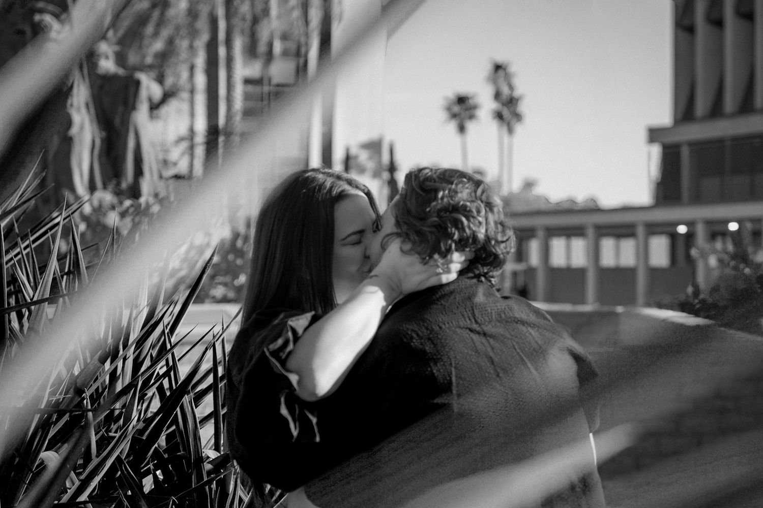 Romantic black and white photograph captured through decorative railings.