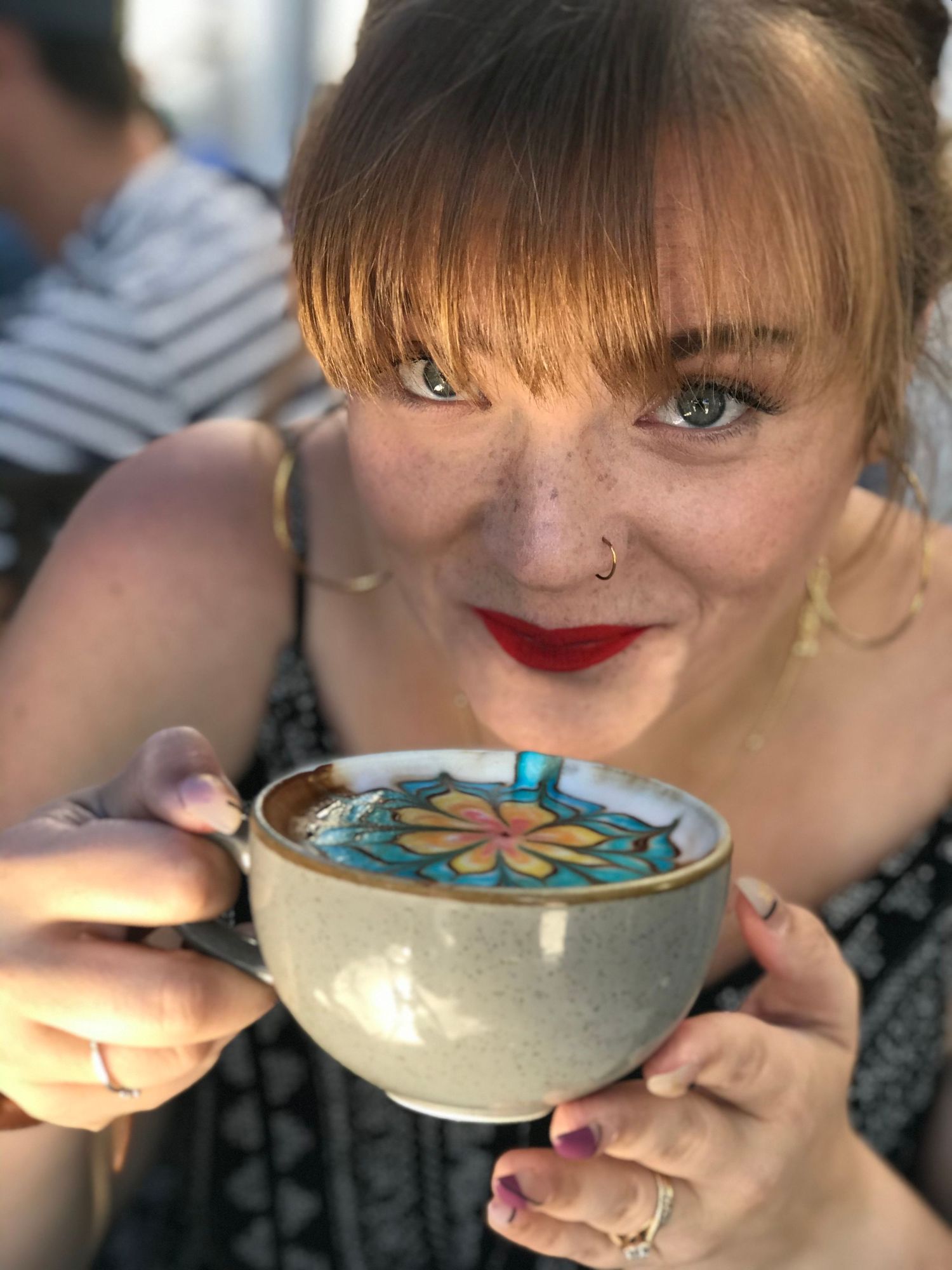 A sequence shows someone sipping and enjoying a beverage from a decorative ceramic bowl with floral designs.