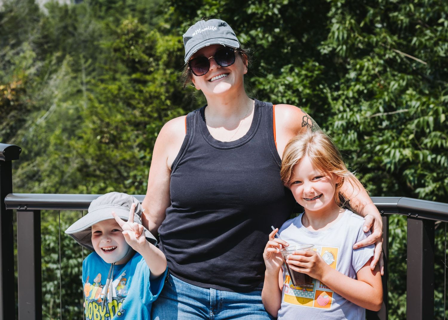 Family members enjoy time together outdoors on a bright sunny day.