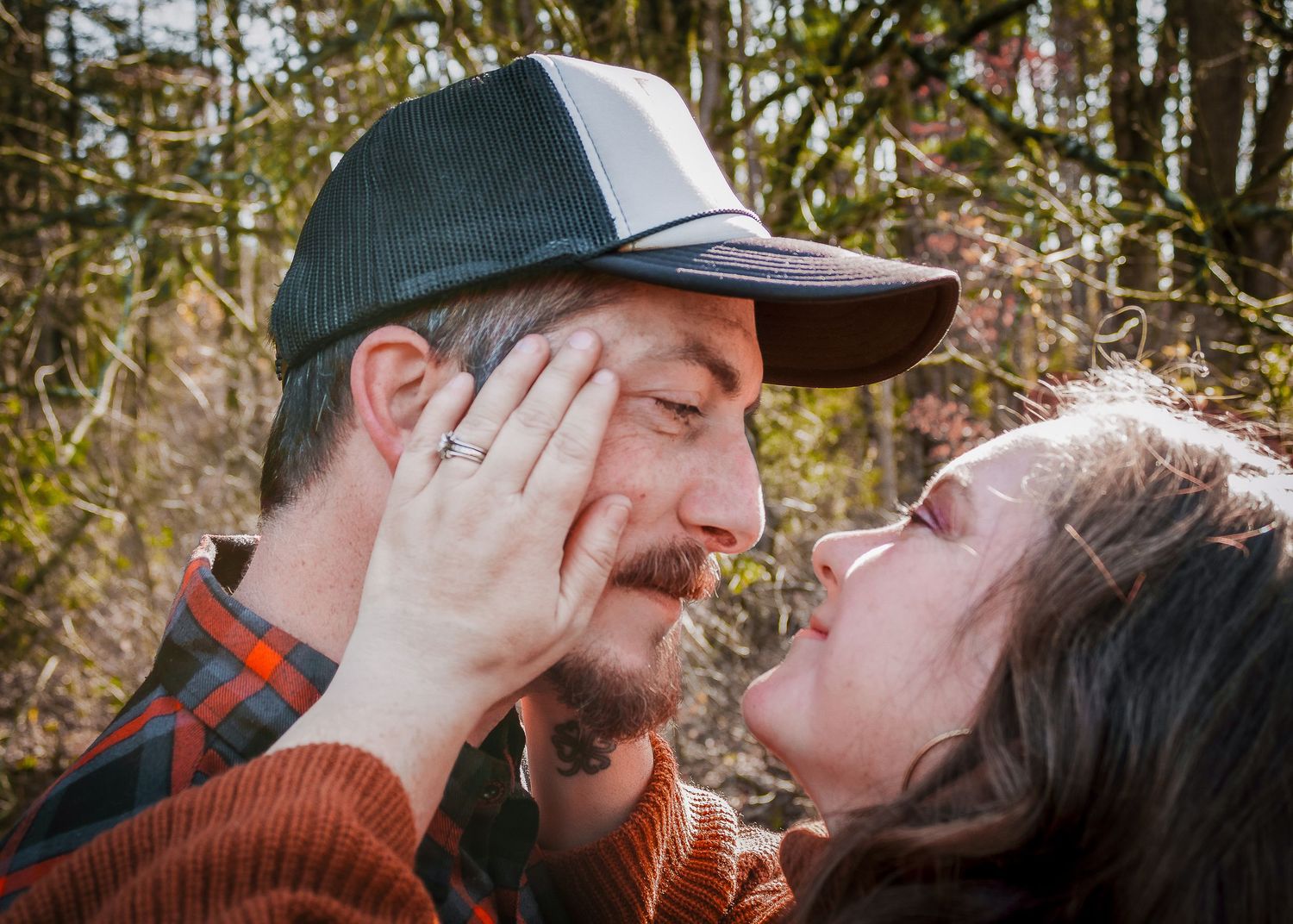 A sequence of images shows intimate moments between two people outdoors in a wooded setting.