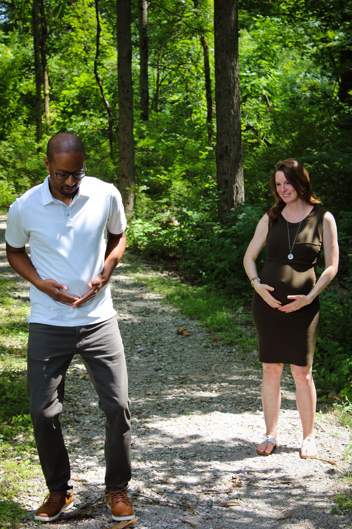 A sequence of candid photos showing people bending down to observe something on a forest trail path.