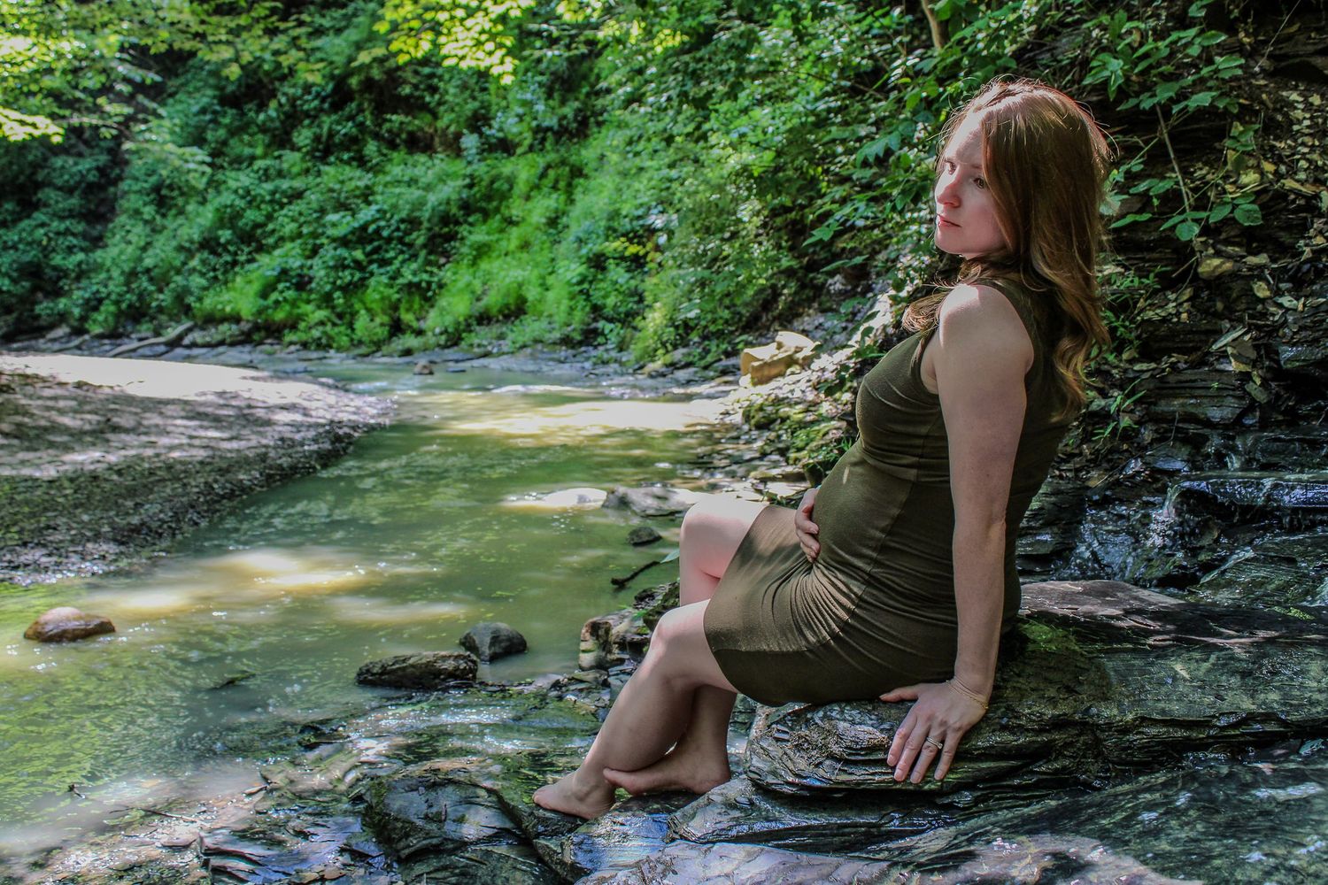 A group of six photos showing someone in olive green relaxing by a rocky stream in the woods.