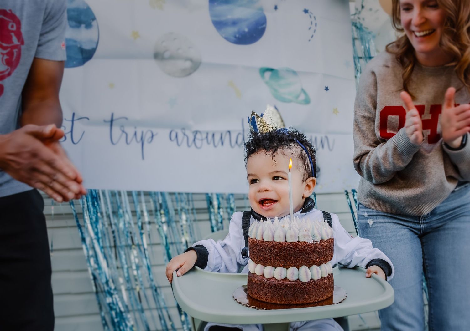 Collage of blue and white first birthday party decorations with smash cake and celebration moments.