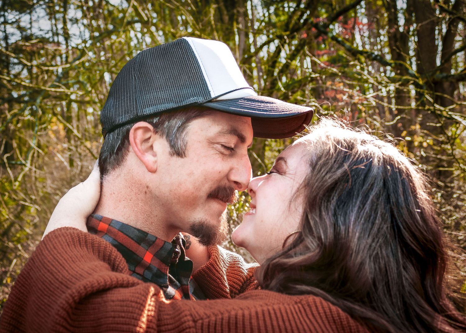 Romantic couple sharing intimate moments in an autumn setting outdoors.