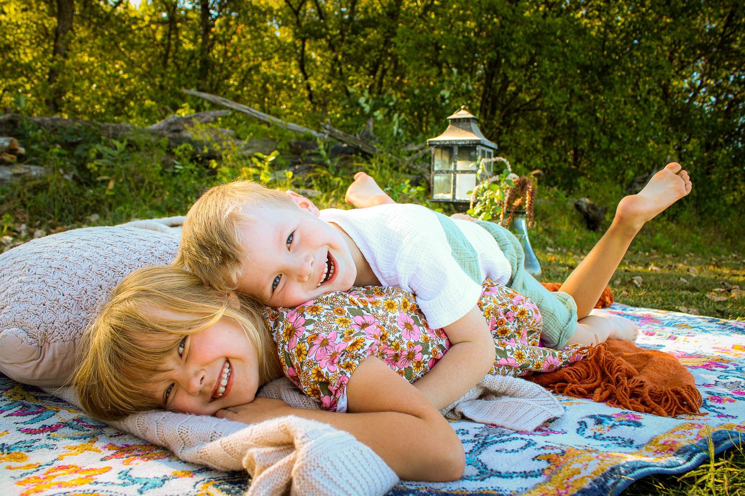 A series of candid outdoor photos shows someone relaxing on a colorful blanket in a sun-dappled garden setting.