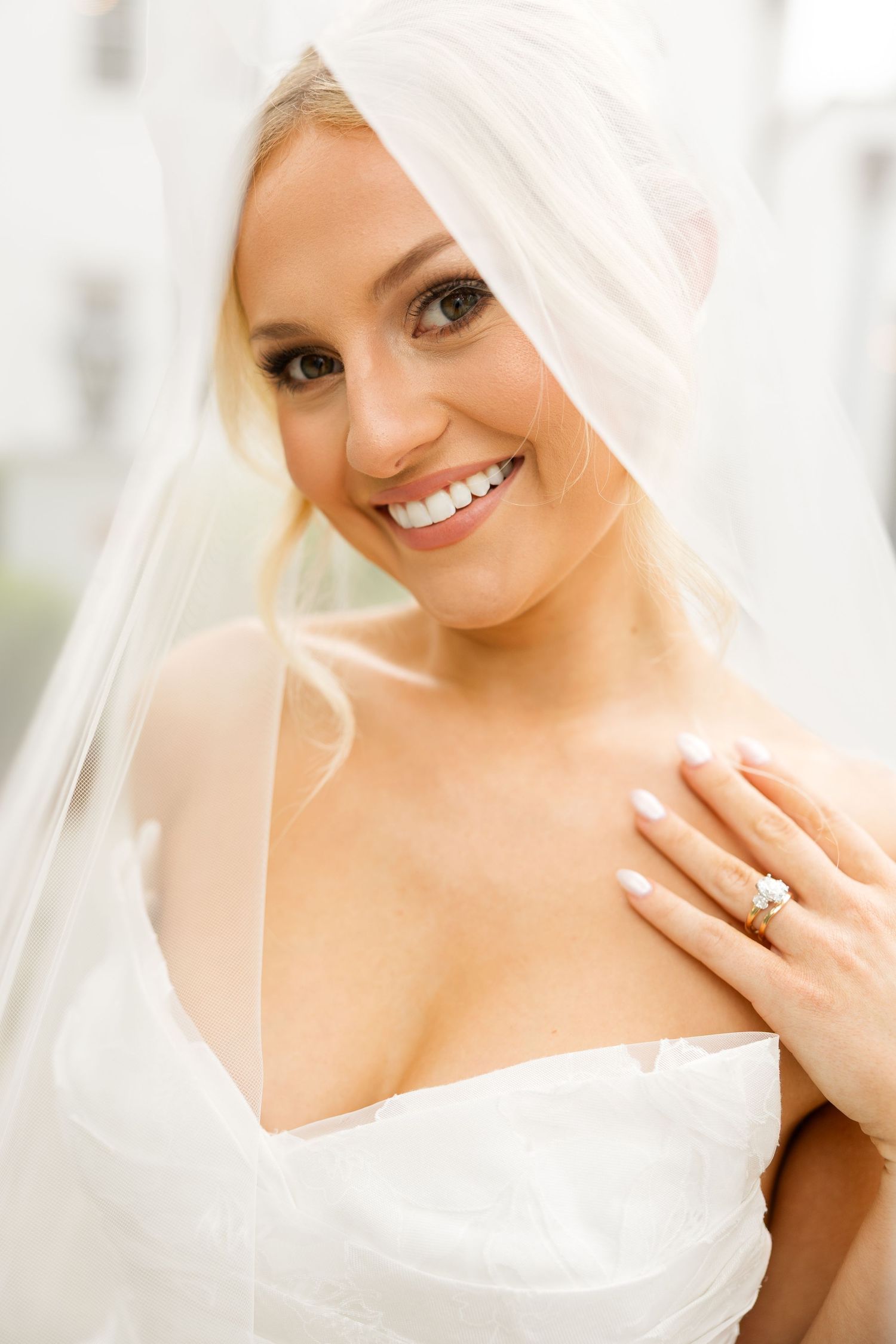 A bridal portrait series showing close-up shots with a flowing white veil and elegant wedding dress.