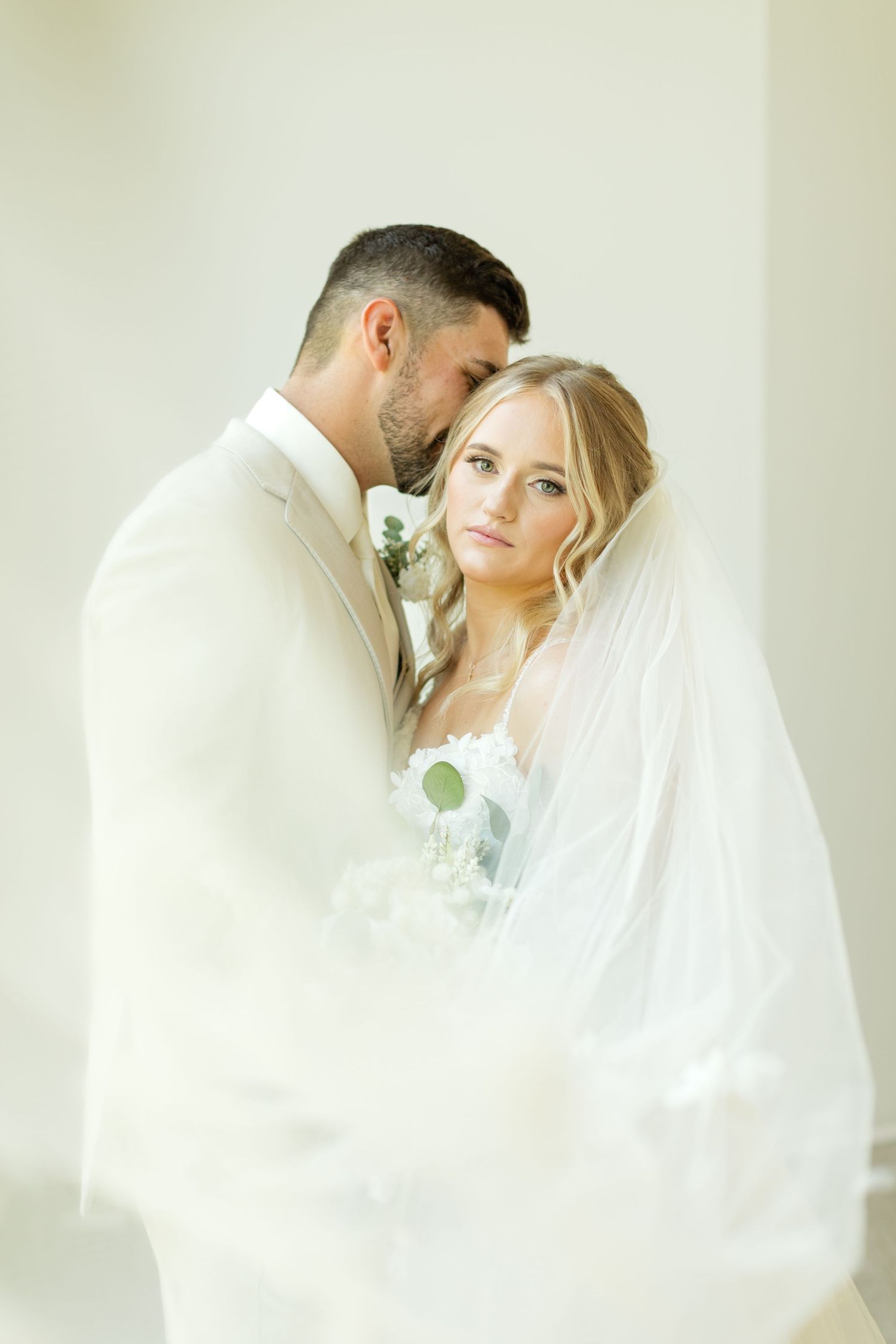 Intimate wedding portraits in a bright minimalist setting with soft white drapery. Legacy Acres