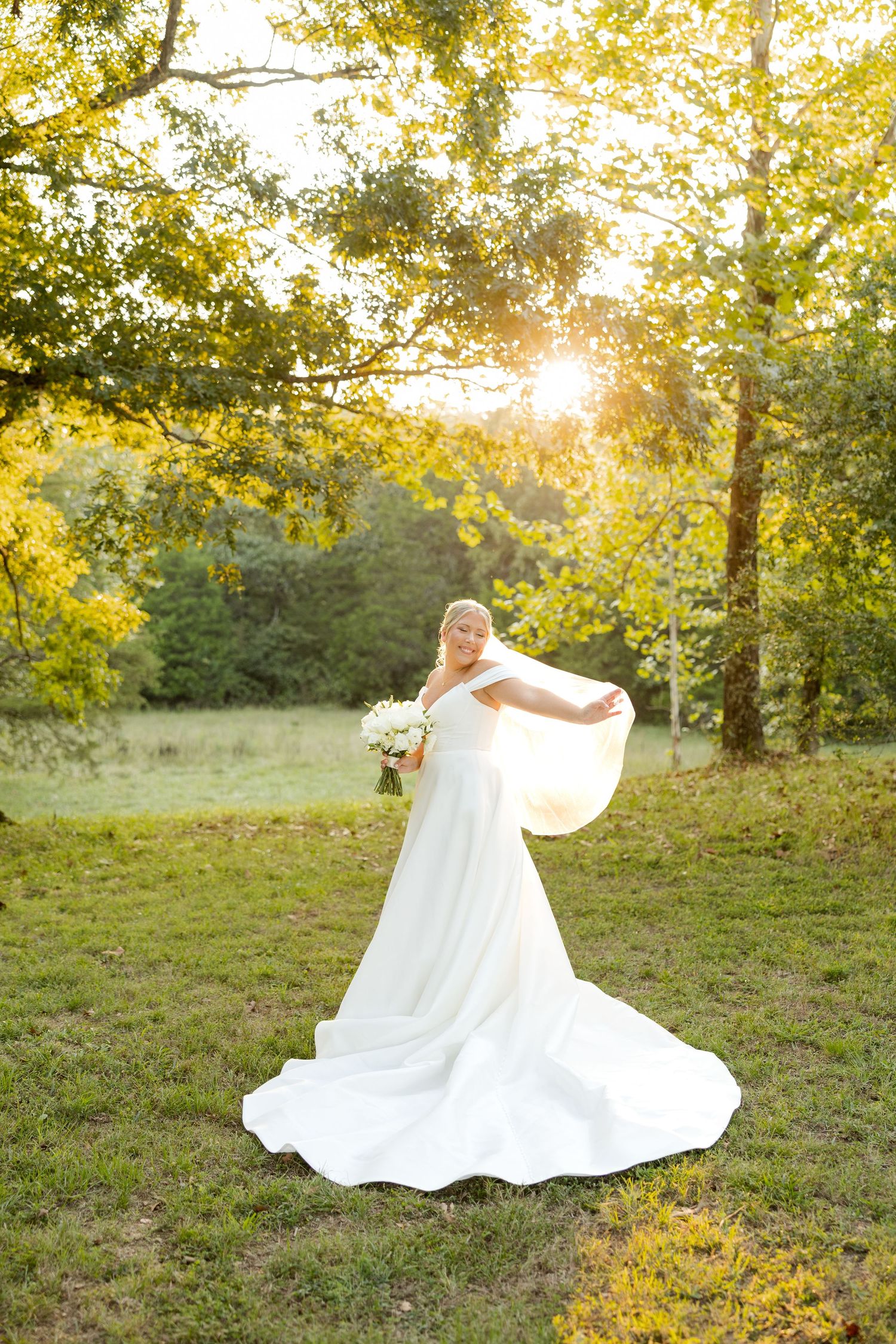 A flowing white wedding dress twirls in motion during an outdoor sunset photo session.
