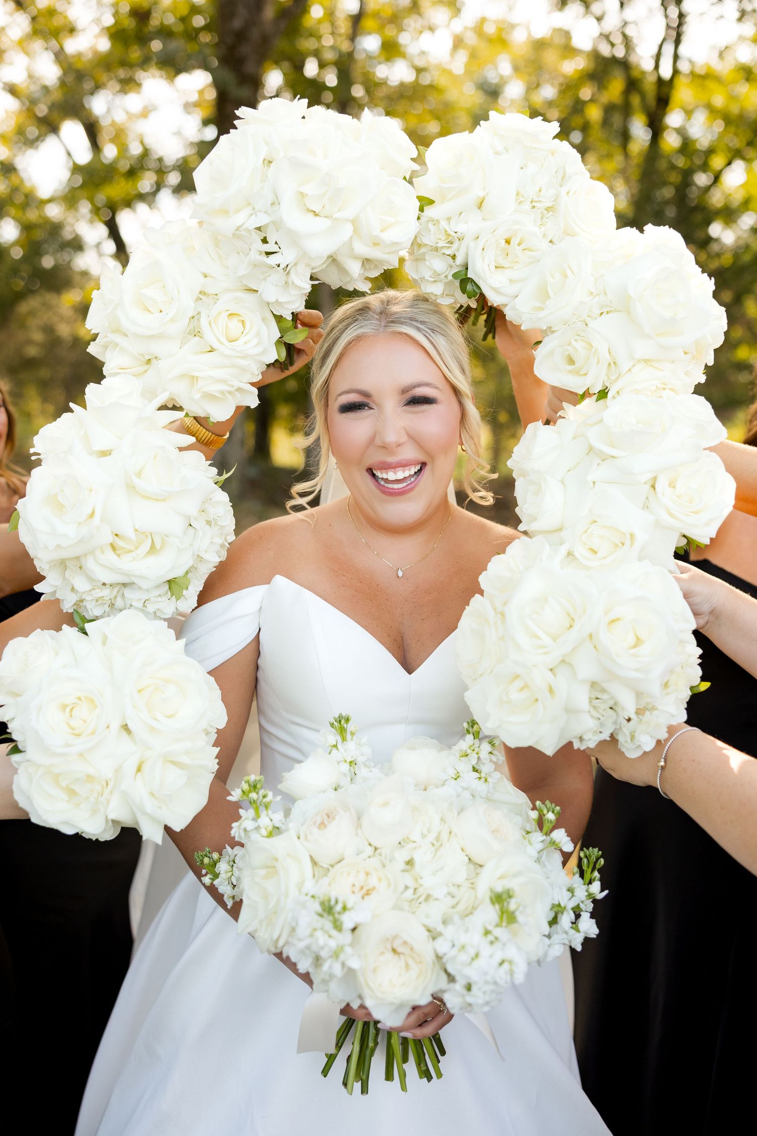 A stunning white bridal bouquet with lush roses and hydrangeas photographed in natural outdoor lighting. Cold Springs Events.