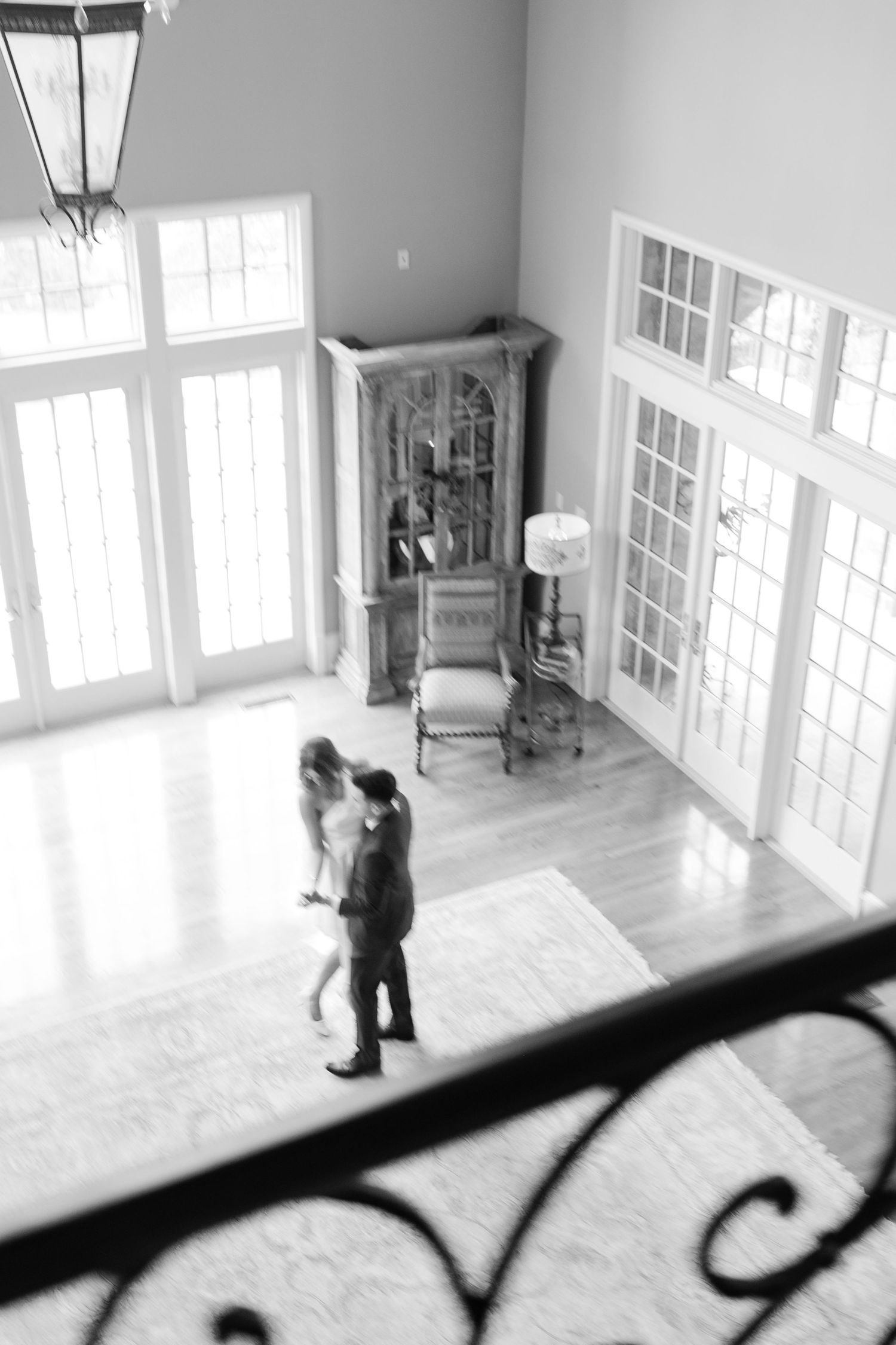 A series of black and white security camera footage stills showing movement in an empty room with large windows. Goodwin Manor.