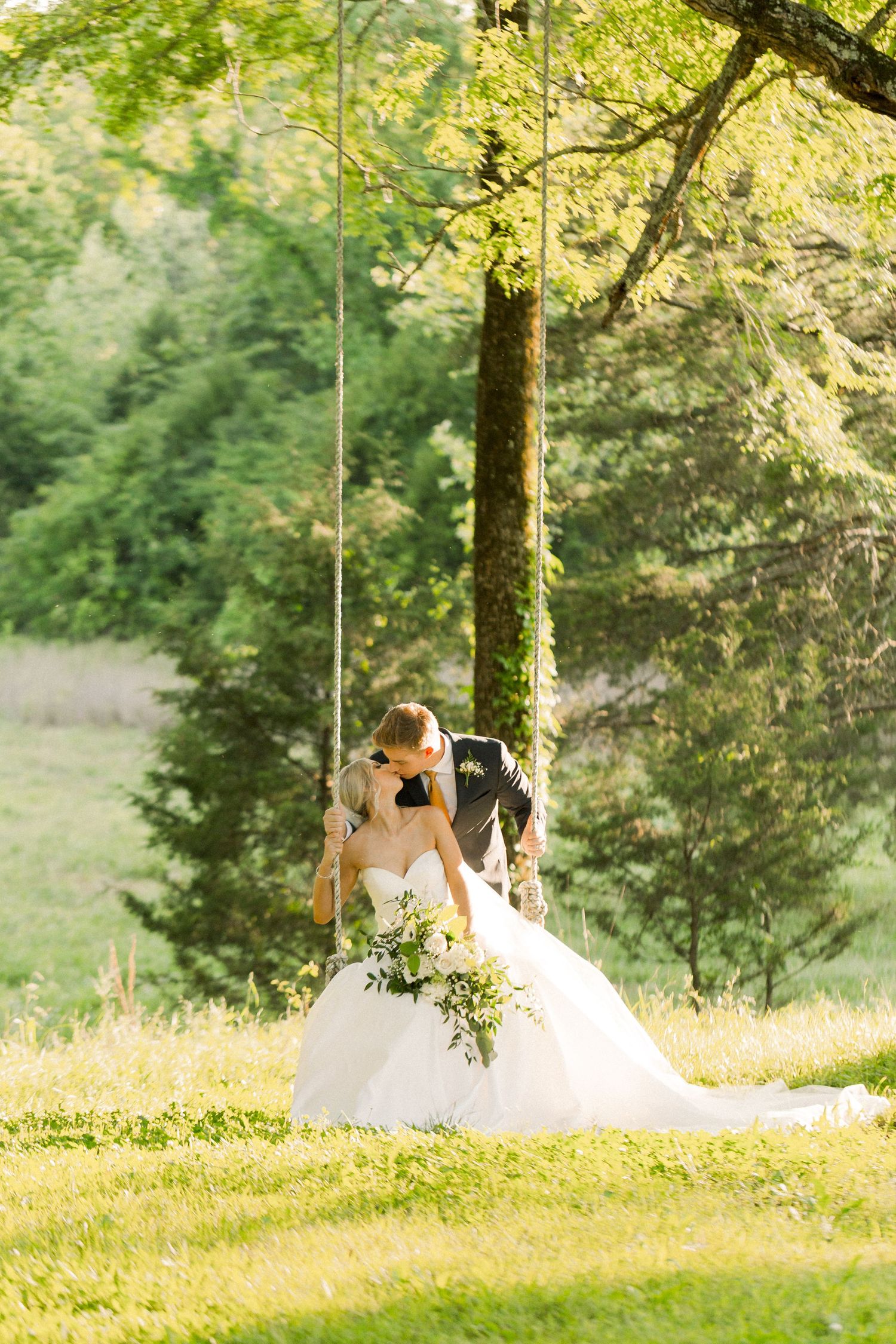 Sunlit meadow scene with wedding dress silhouette under tree branches. Cold Springs.