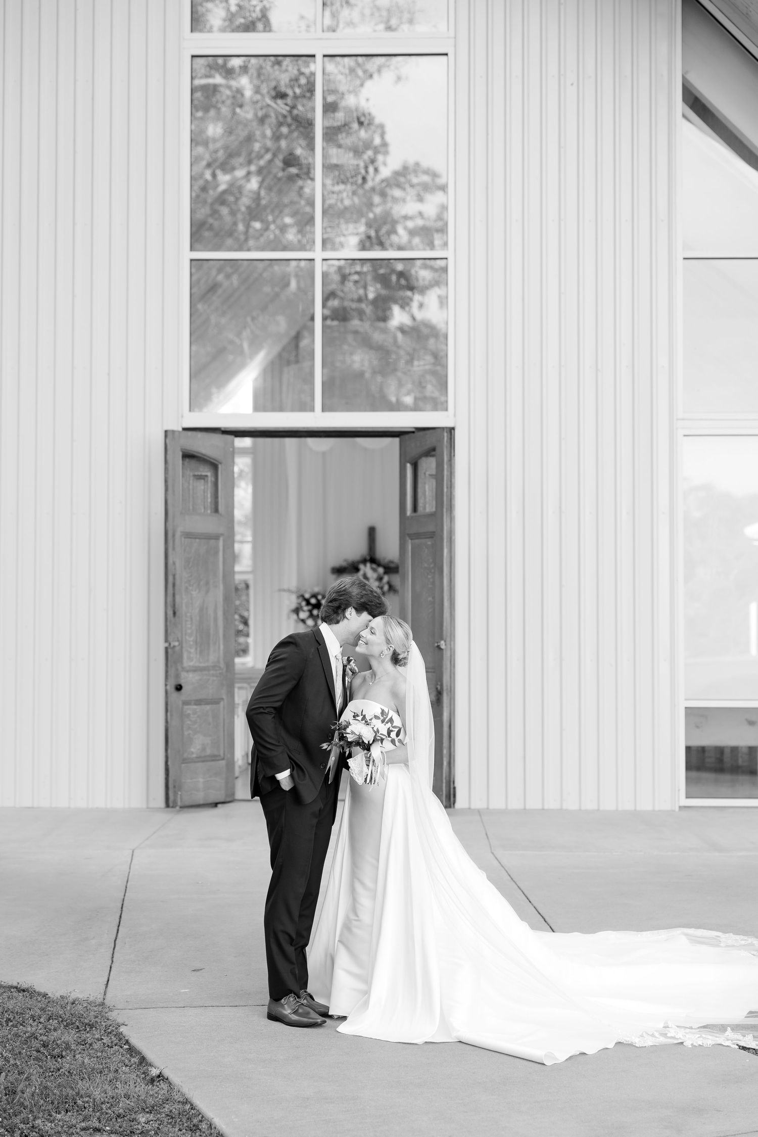 Classic wedding portraits captured outside modern white church building. Cold Springs Events