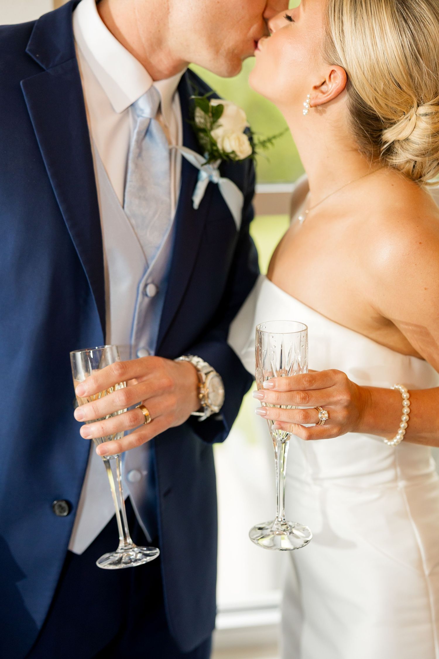 Close up of wedding couple holding champagne glasses during celebration toast.Cold Springs Events
