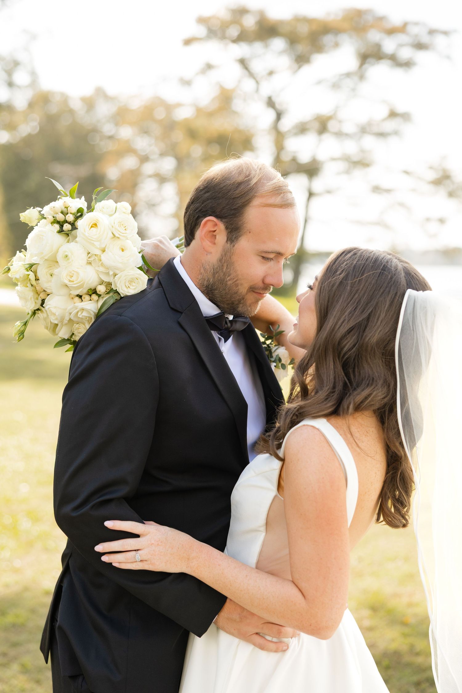 Romantic wedding portrait of couple embracing outdoors in formal attire.Marlgsate Plantation