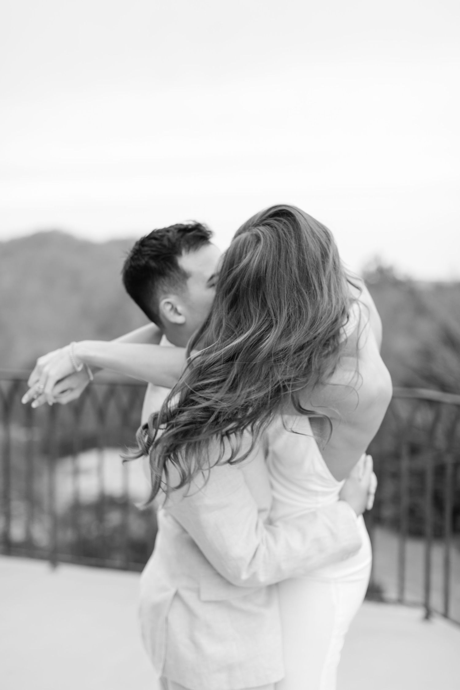 A series of artistic black and white photos showing joyful embraces outdoors. Goodwin Manor.