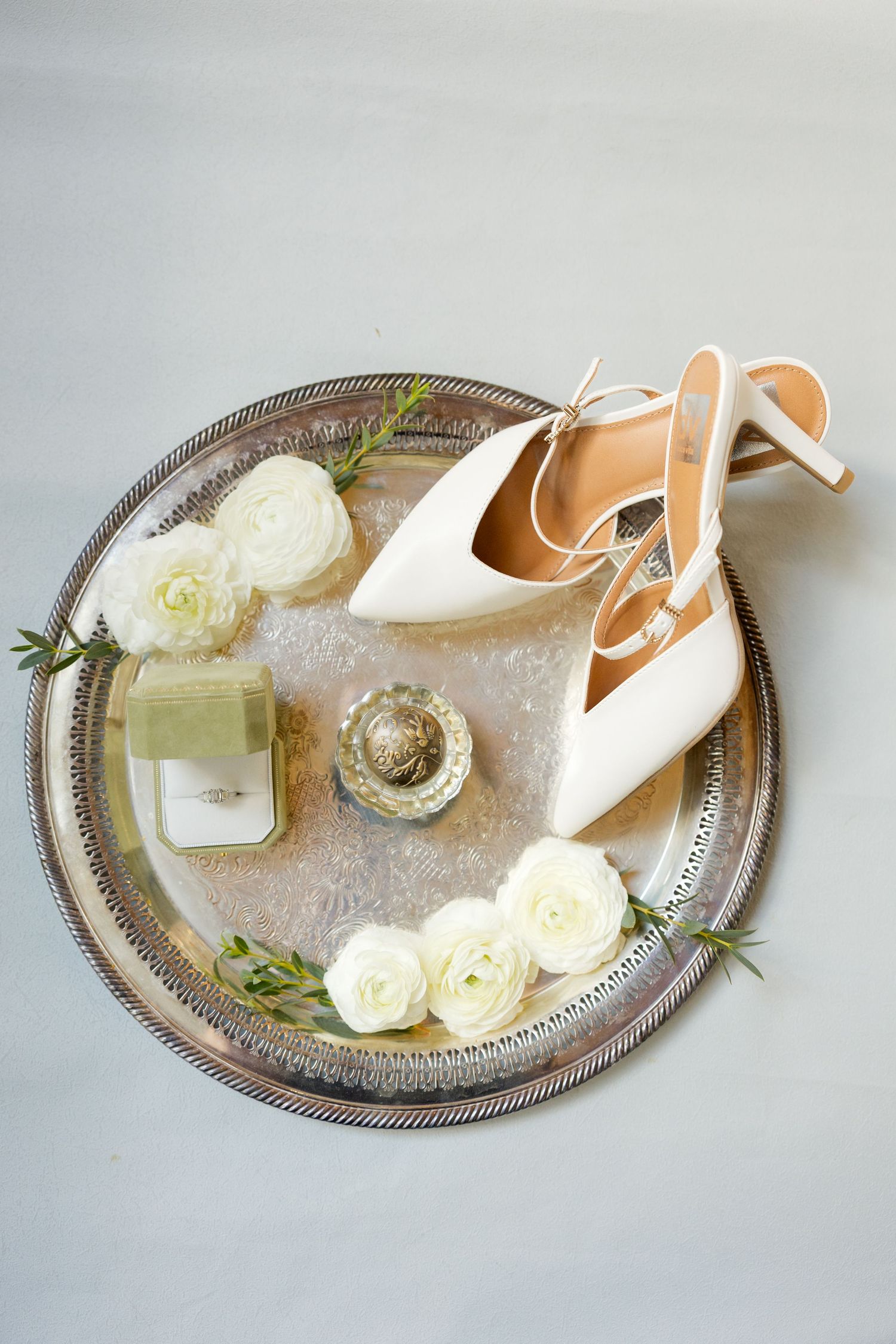 Vintage silver tray with white bridal shoes, roses and wedding accessories.Marlgsate Plantation