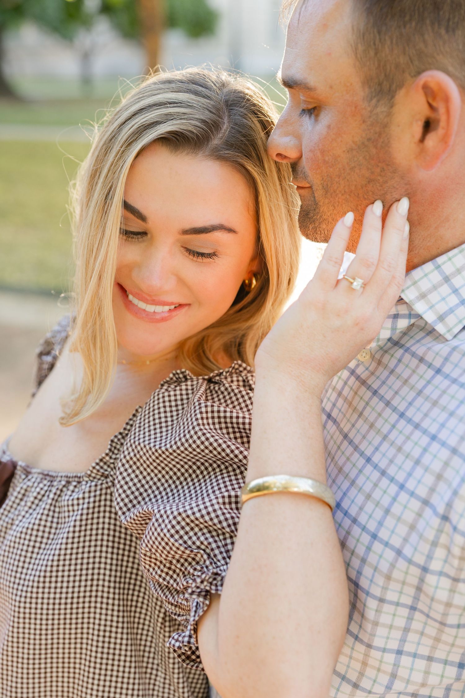 A romantic engagement photo series showing a couple embracing outdoors in natural lighting.