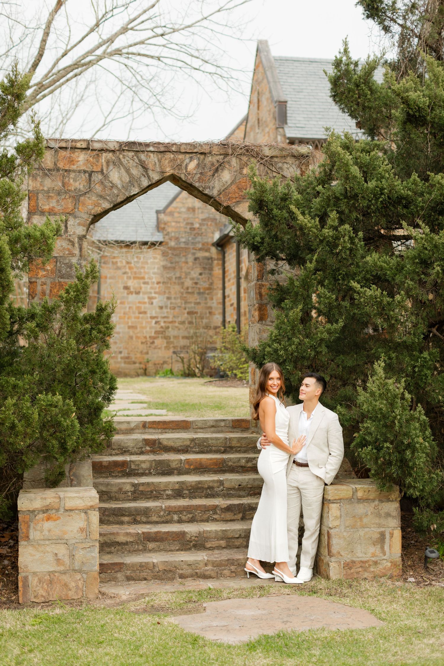 Stone steps and brick walls create romantic backdrop for couple's engagement photos. Goodwin Manor.