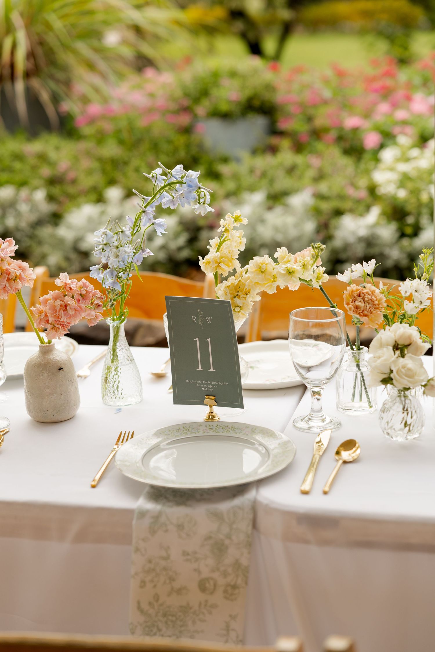 Elegant wedding reception table settings with floral centerpieces and numbered table cards.Botanical Gardens of the Ozarks