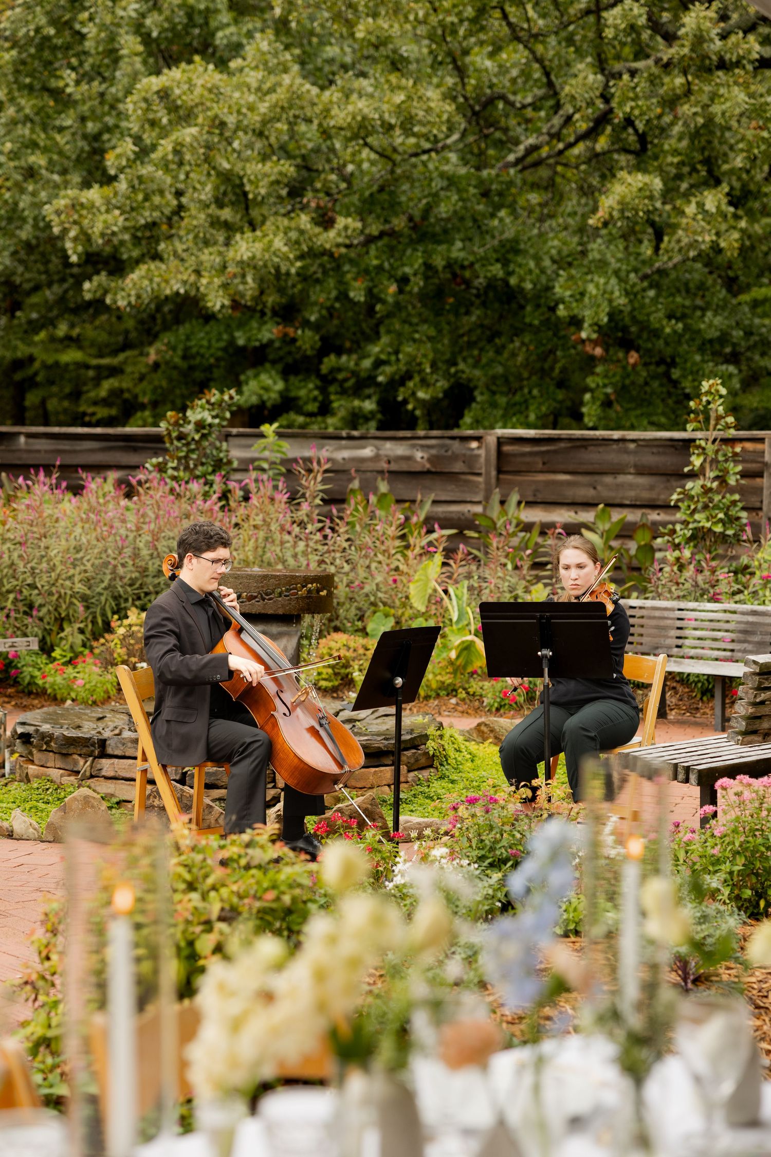 String musicians perform in an outdoor garden setting during a wedding ceremony. Botanical Gardens of the Ozarks