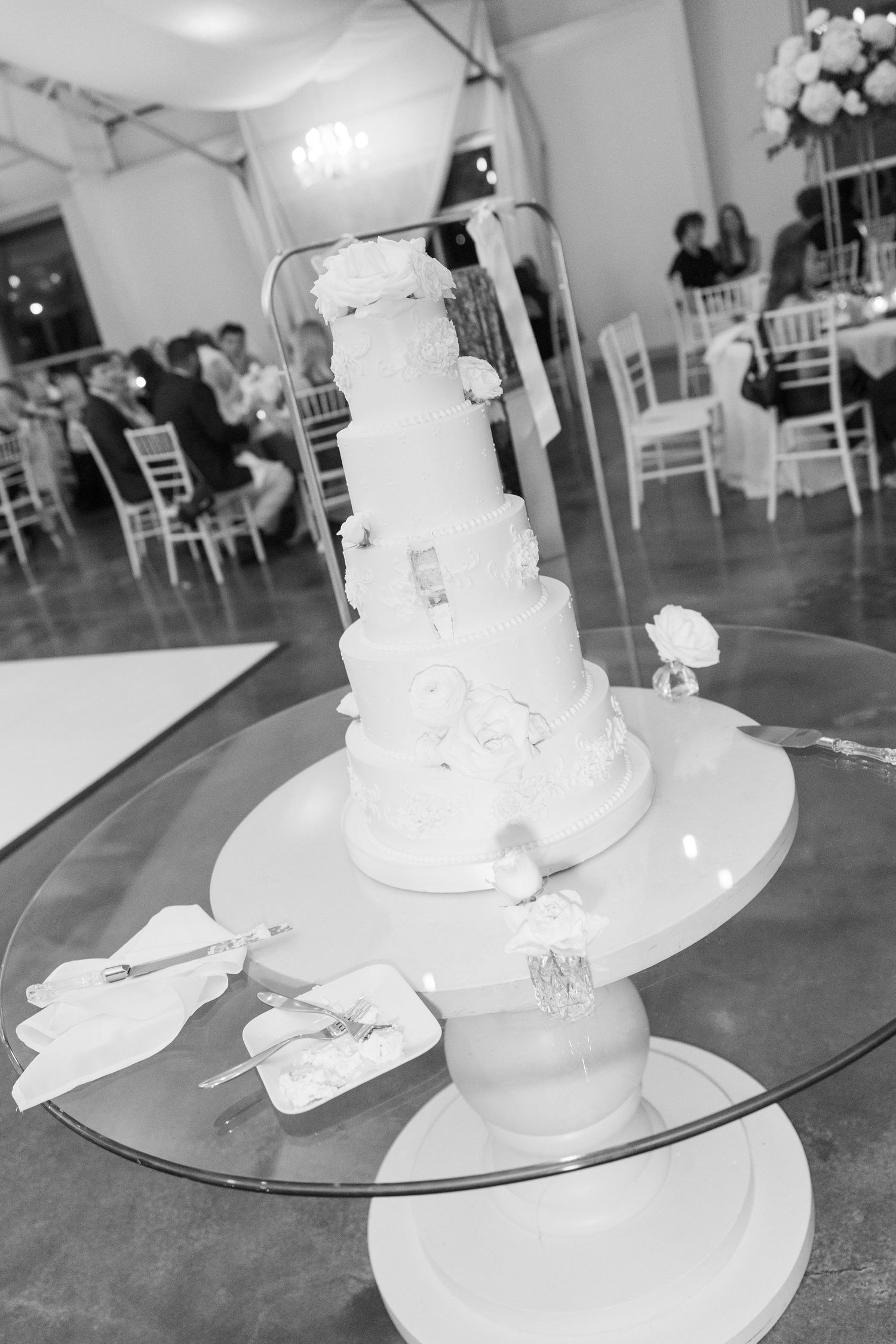 A series of white wedding cake photos showing different angles of an elegant tiered cake with floral decorations. Cold Springs Events