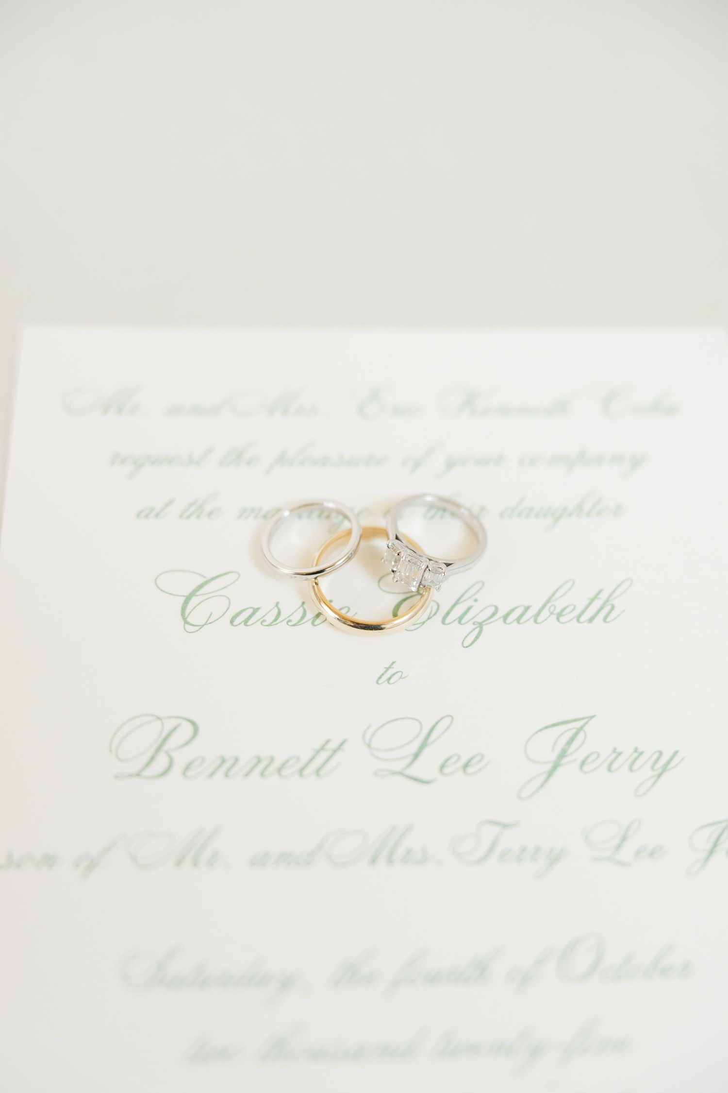 Elegant wedding invitation text showing names in calligraphy script on cream colored paper.