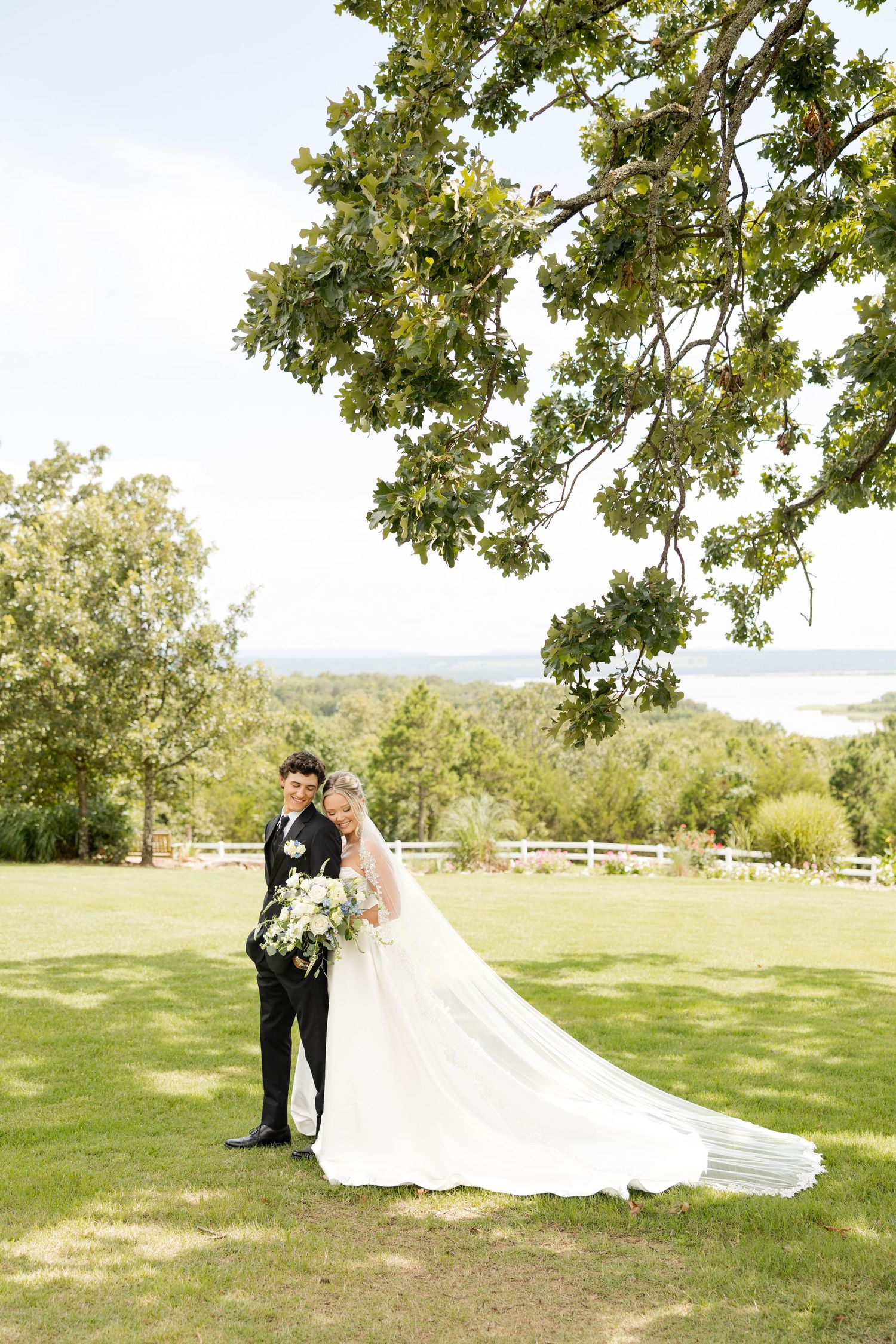 A romantic wedding photo series showing a couple in a sunlit field with a flowing white dress and veil. Cabin Creek Lookout