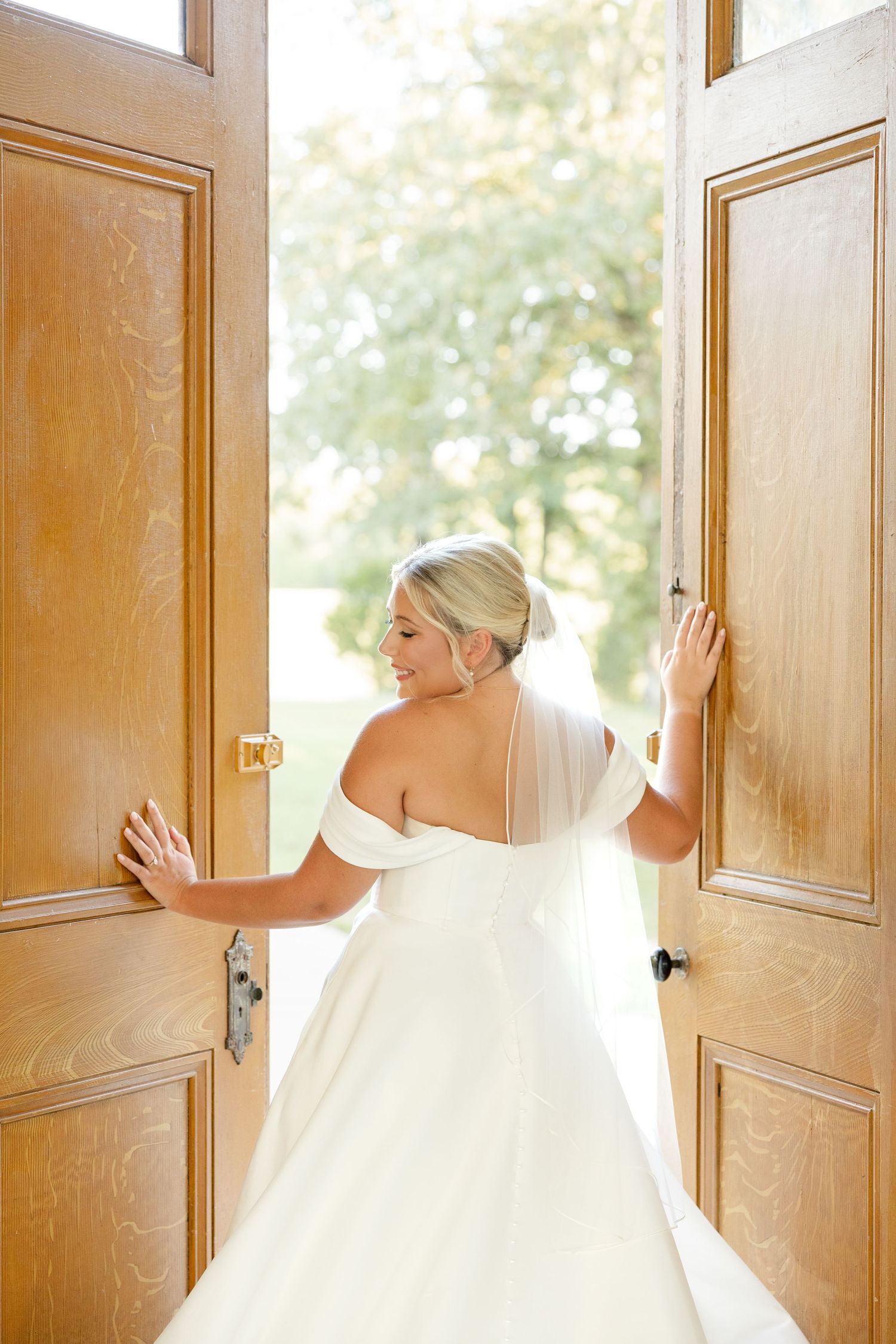 A sequence of photos showing a bride in a white wedding dress opening wooden church doors.