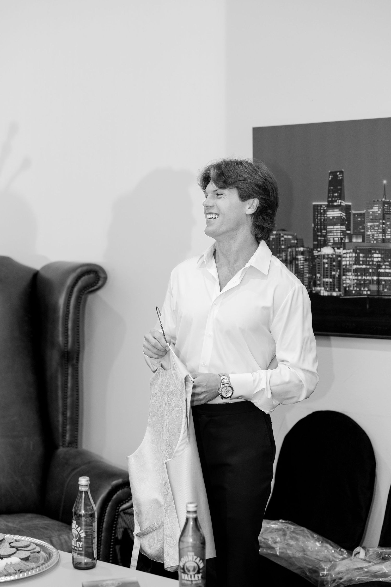 Black and white photo series showing a person in white shirt standing against a cityscape backdrop at Cold Springs