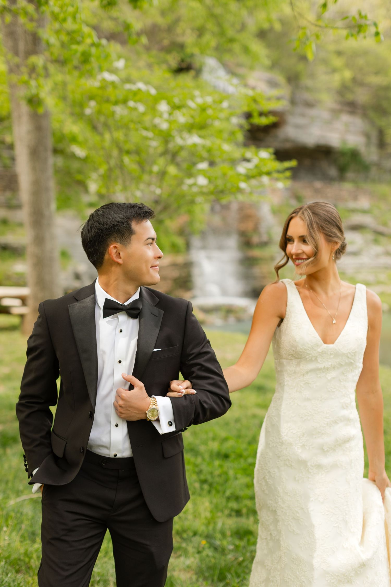 A candid wedding moment captured in a lush garden setting. Dogwood Canyon.