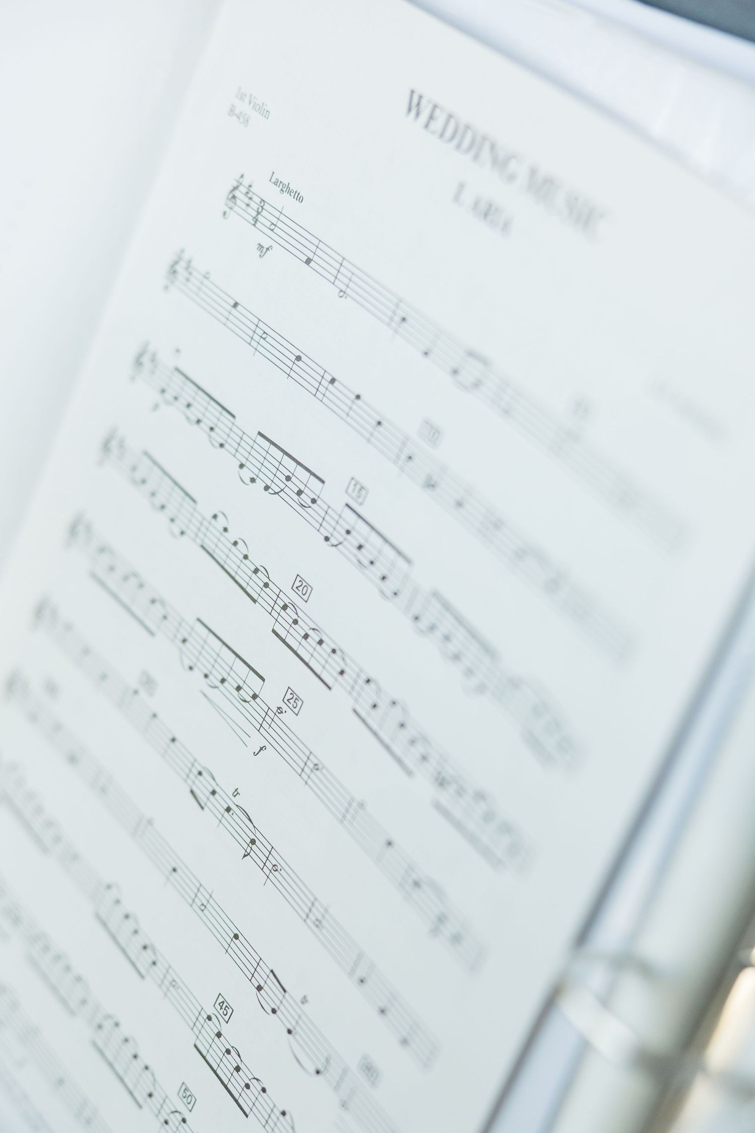 Sheet music pages with musical notes and staffs shown in soft focus with blurred edges. Cold Springs Events.
