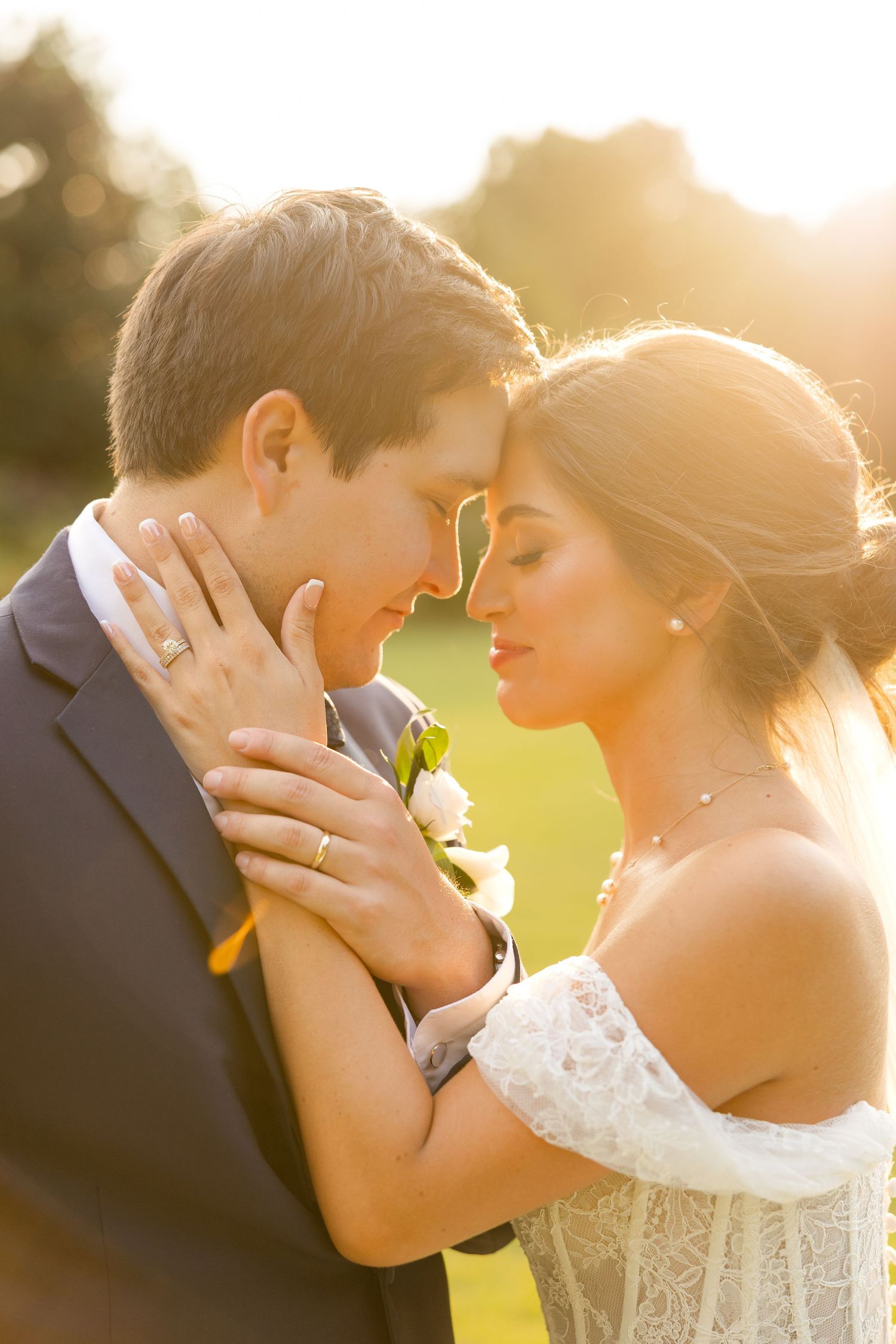 Romantic sunset portrait of newlyweds sharing an intimate moment in golden light.Botanical Gardens of the Ozarks
