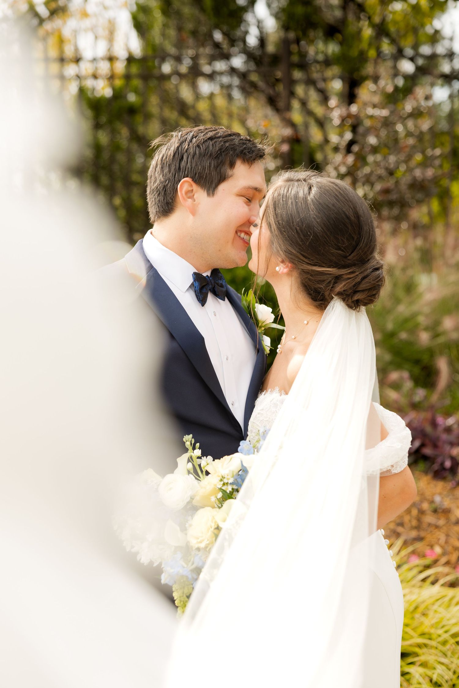 Romantic wedding portrait captured through soft focus in an autumn garden setting.Botanical Gardens of the Ozarks