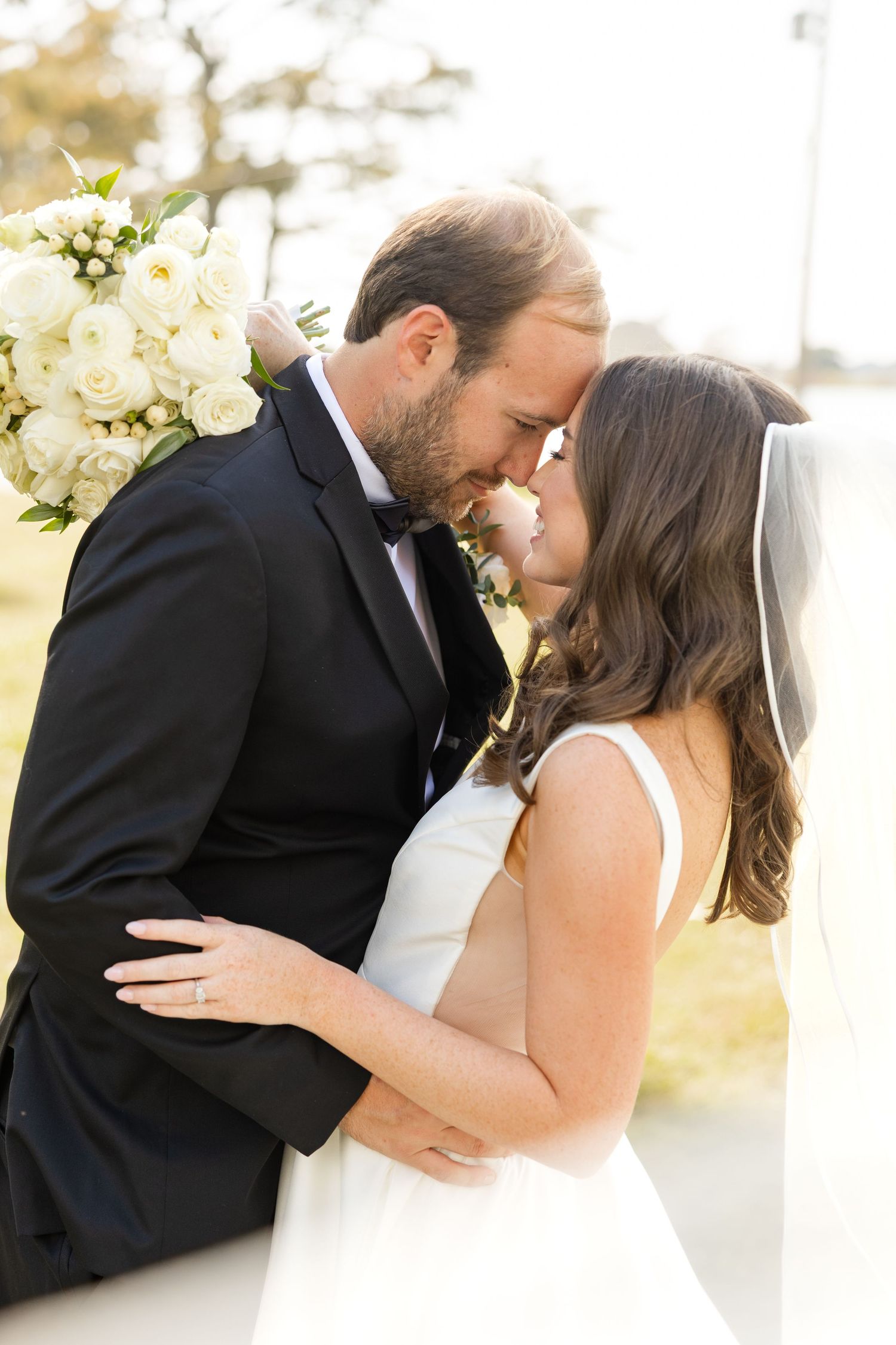 Intimate wedding portrait captures tender romantic moment between newlyweds.