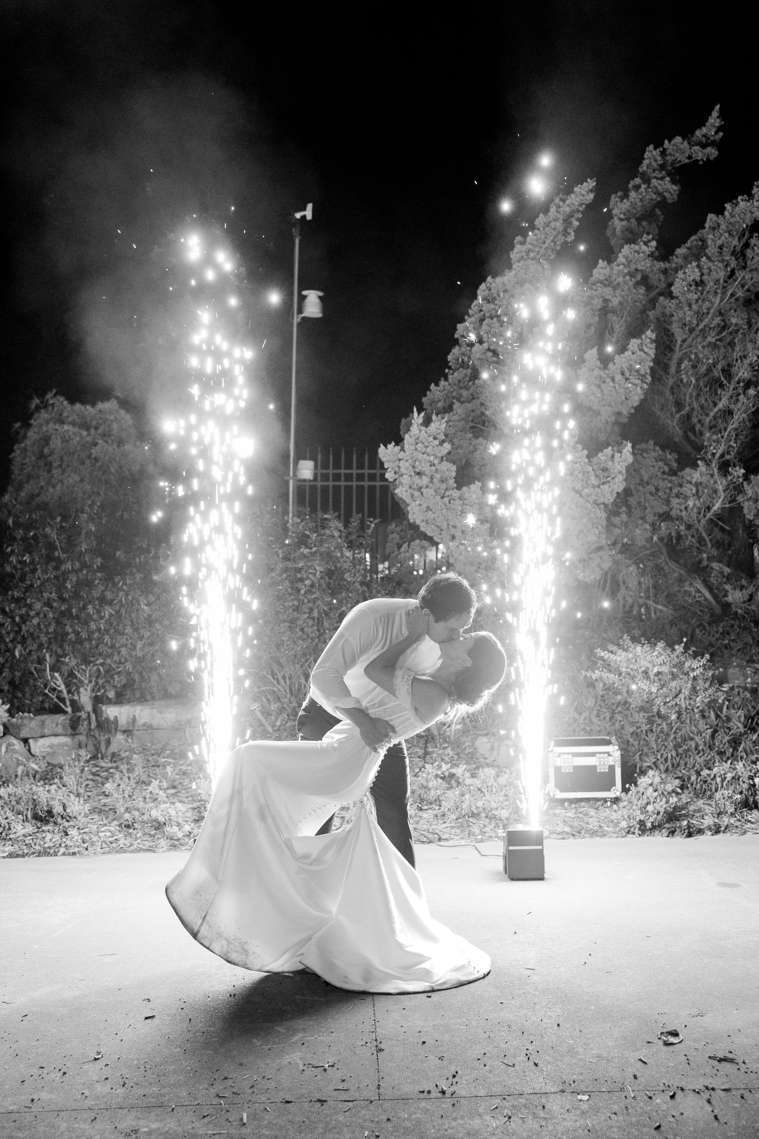 Dramatic nighttime wedding scene with sparklers creating a magical backdrop for a romantic dance.Botanical Gardens of the Ozarks