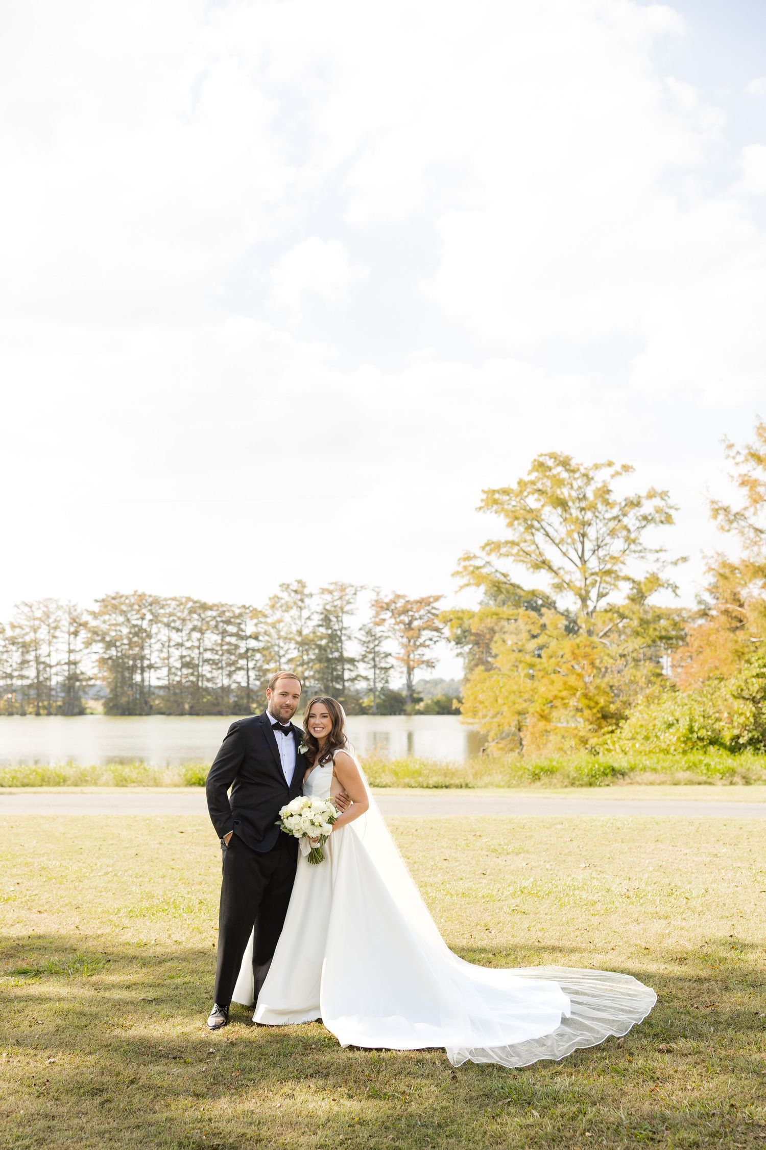 Wedding couple shares intimate moments in an open field during golden hour.