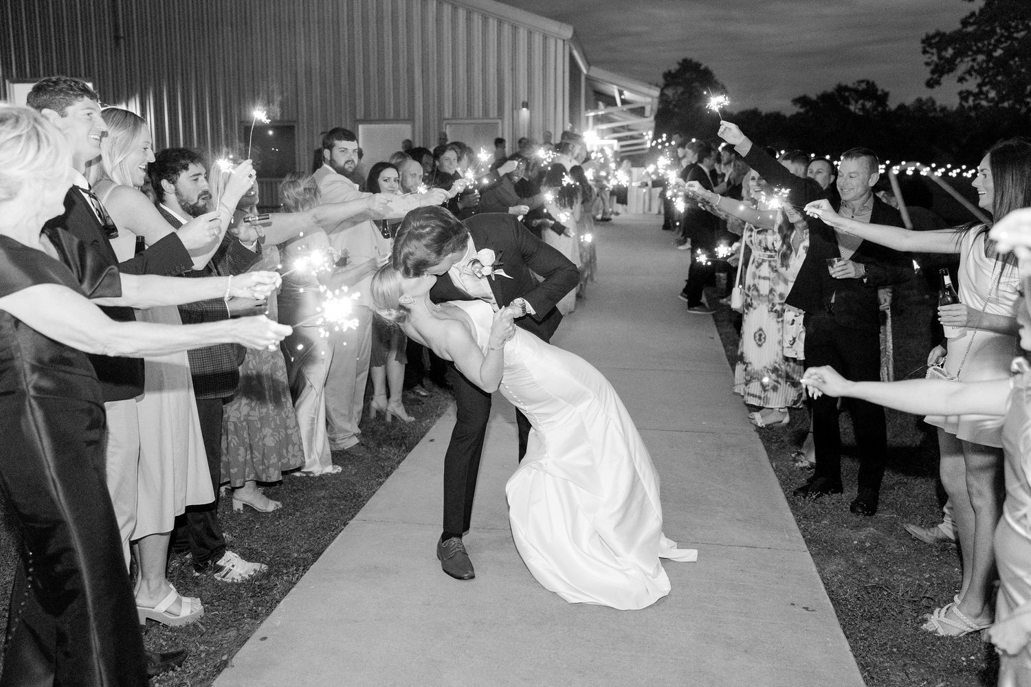 Wedding guests dancing and celebrating at an outdoor evening reception. Cold Springs Events