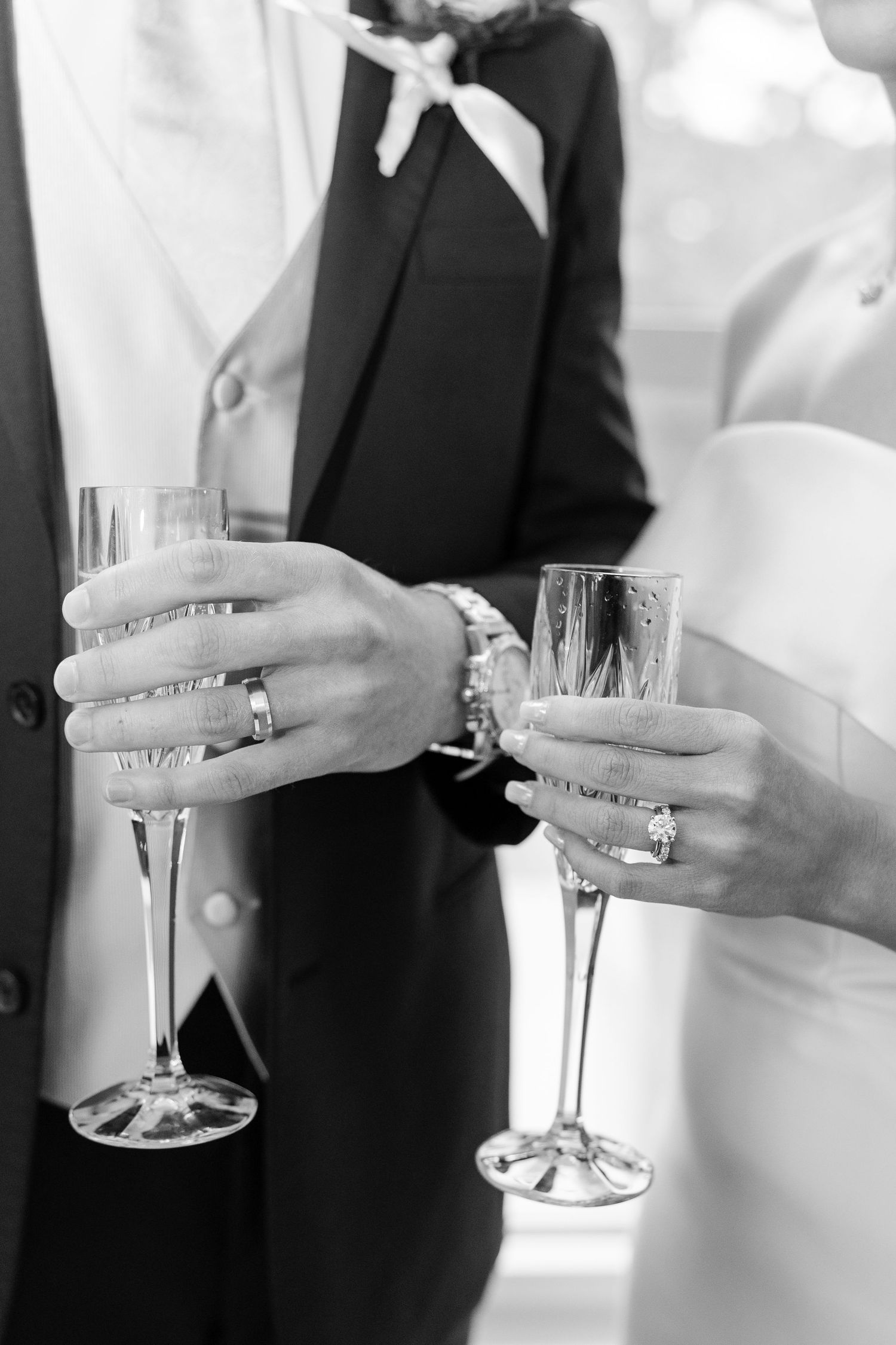 Champagne toast with crystal flutes showing elegant rings and formal attire. Cold Springs Events