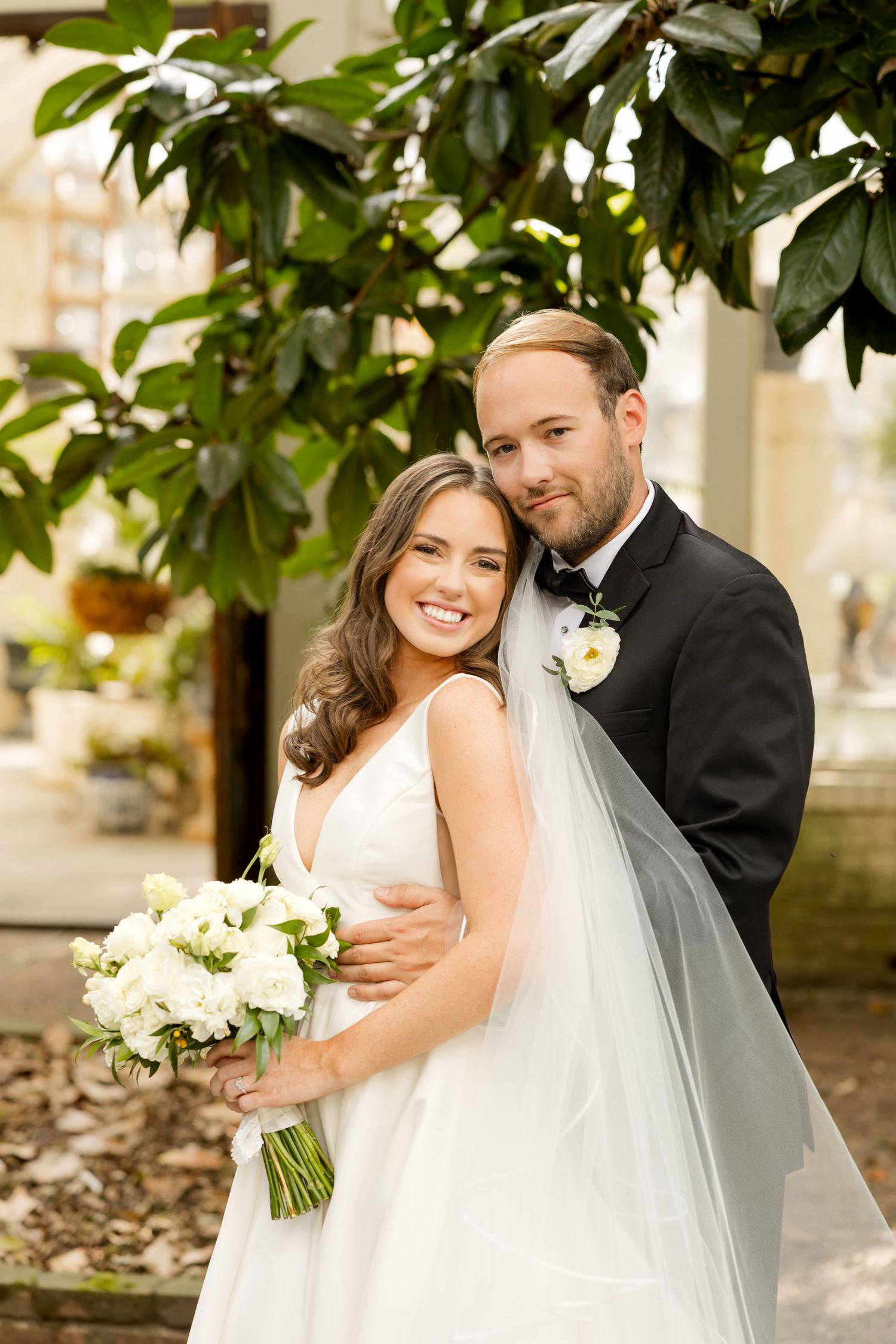 A romantic wedding photoshoot series showing tender moments between a bride and groom outdoors with lush greenery.