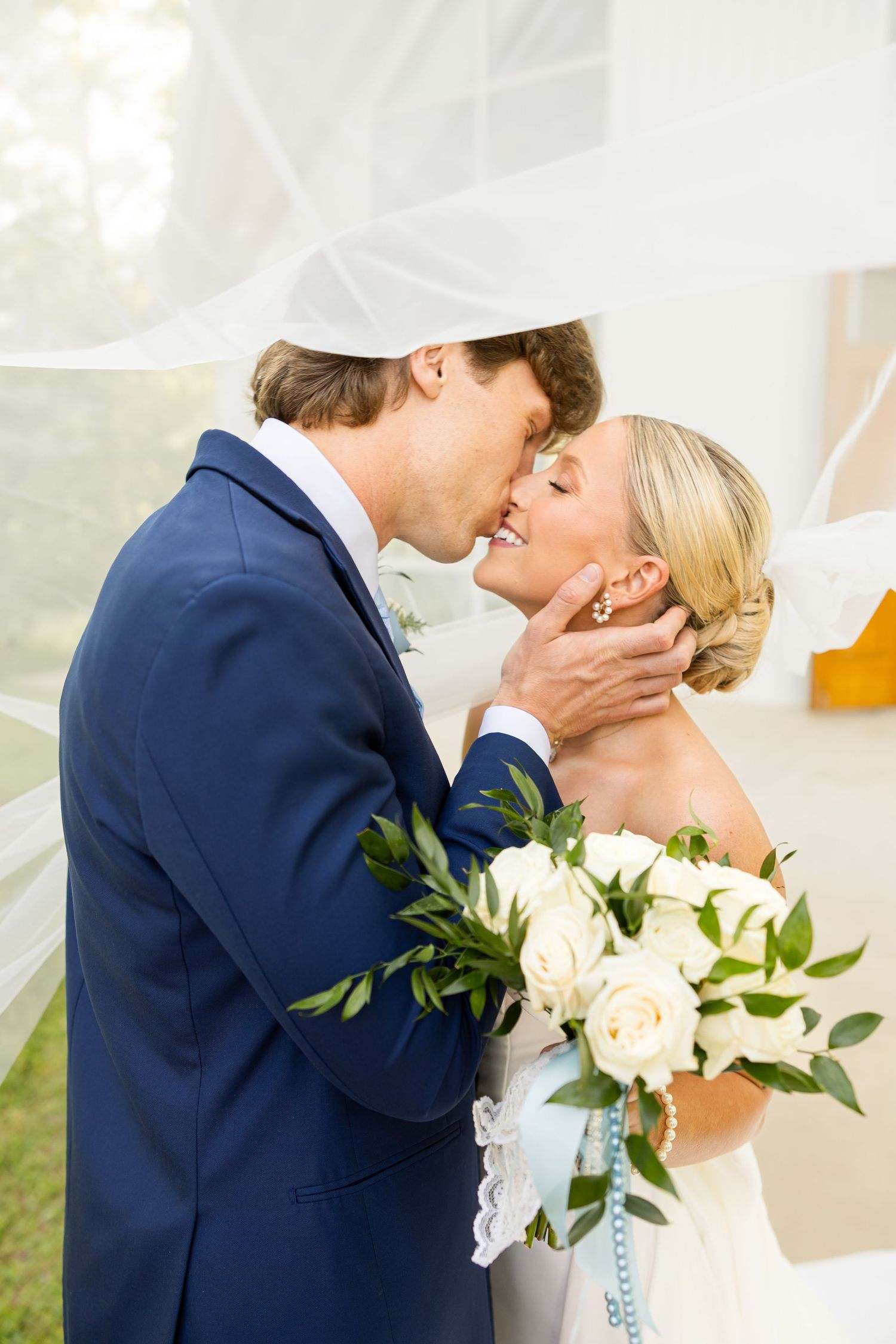 Romantic wedding portrait with white roses and flowing veil. Cold Springs Events