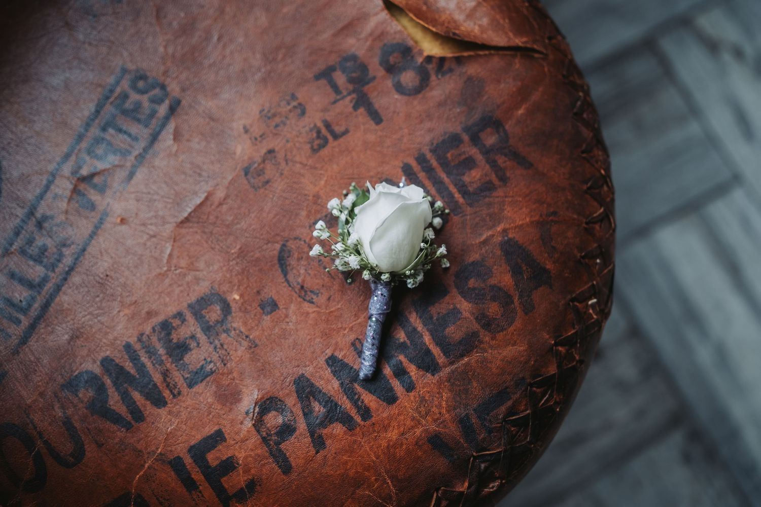 Close-up detail shot of a vintage leather baseball glove with worn text visible.